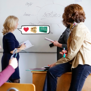 Three people discuss in front of a whiteboard with "sorties" written. Bubble shows heart, tickets, and museum sign, suggesting outing ideas.