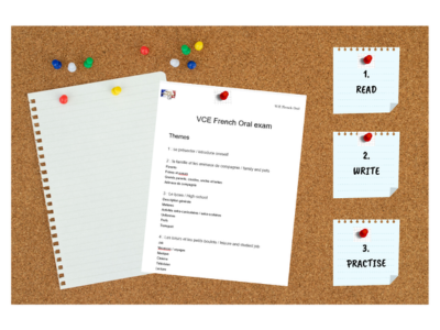 A wooden pin board with revision pages for the VCE French oral exam pinned