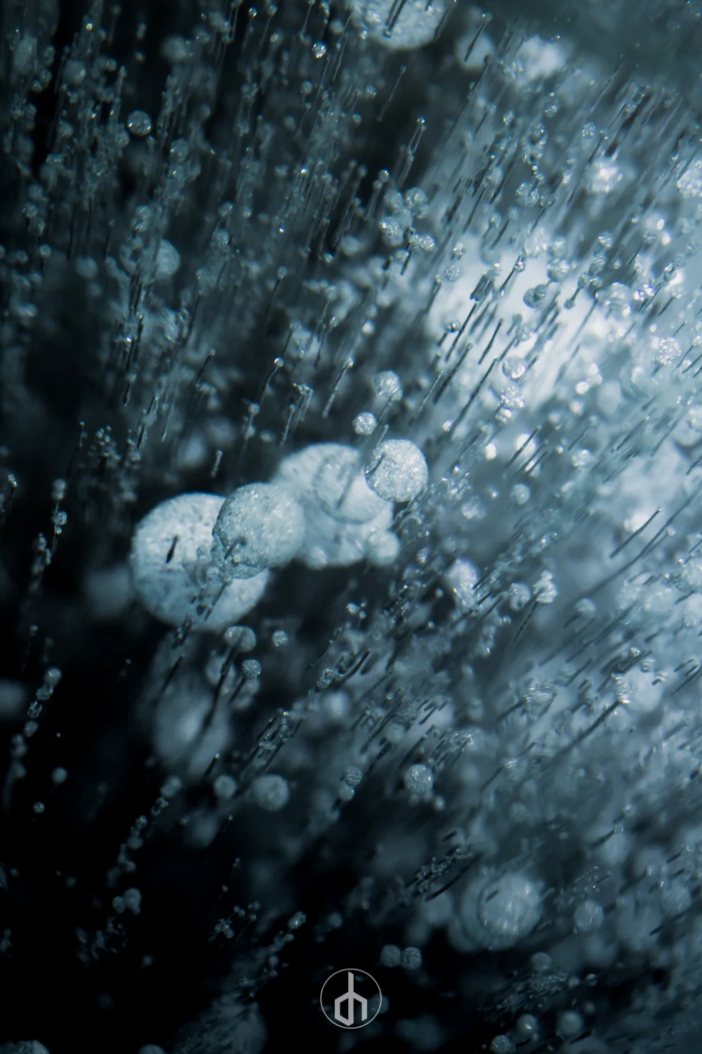 Close-up of water droplets on a surface, creating a sparkling, abstract pattern.