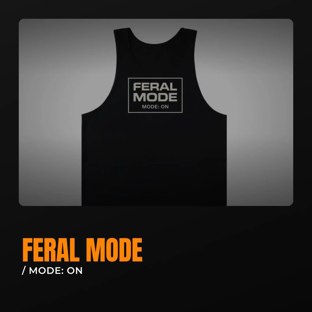 Some rooms are full of tame fits. This tank isn't one of them.

FERAL MODE / MODE: ON, printed right across the chest.

No speech needed. The graphic says where you stand before you open your mouth.

Grab the MODE: ON tank through the shop link in bi