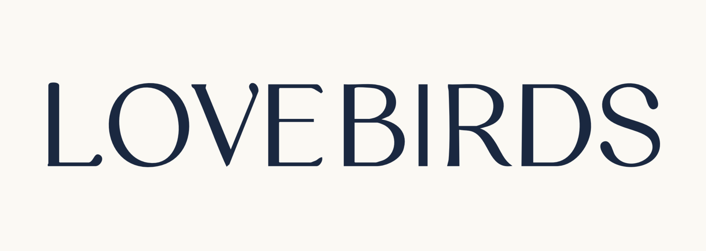 Text reading "LOVEBIRDS" in large, navy blue letters on a light background.