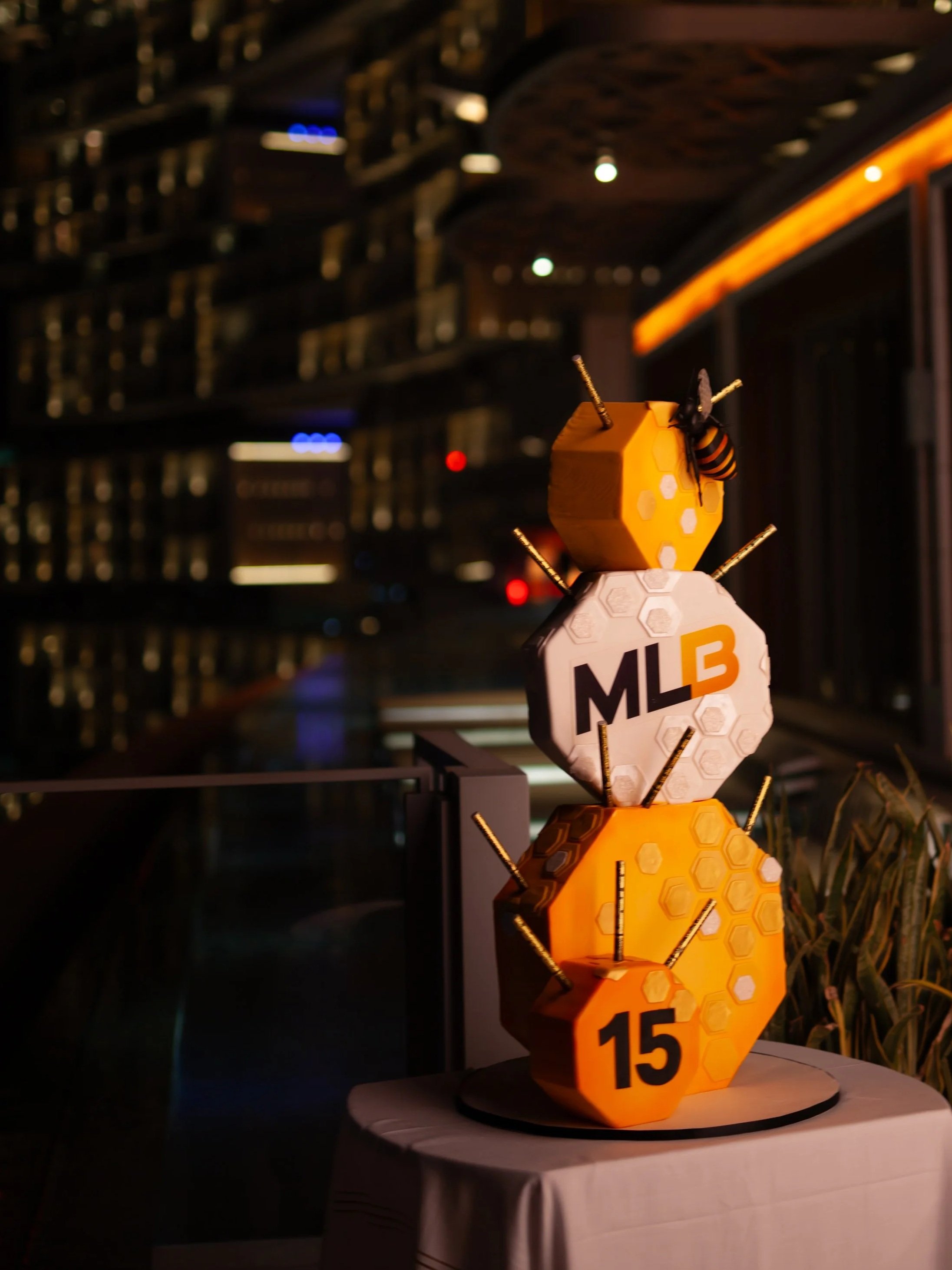 Bespoke honeycomb-inspired MLB celebration cake with bee details and personalised design elements.