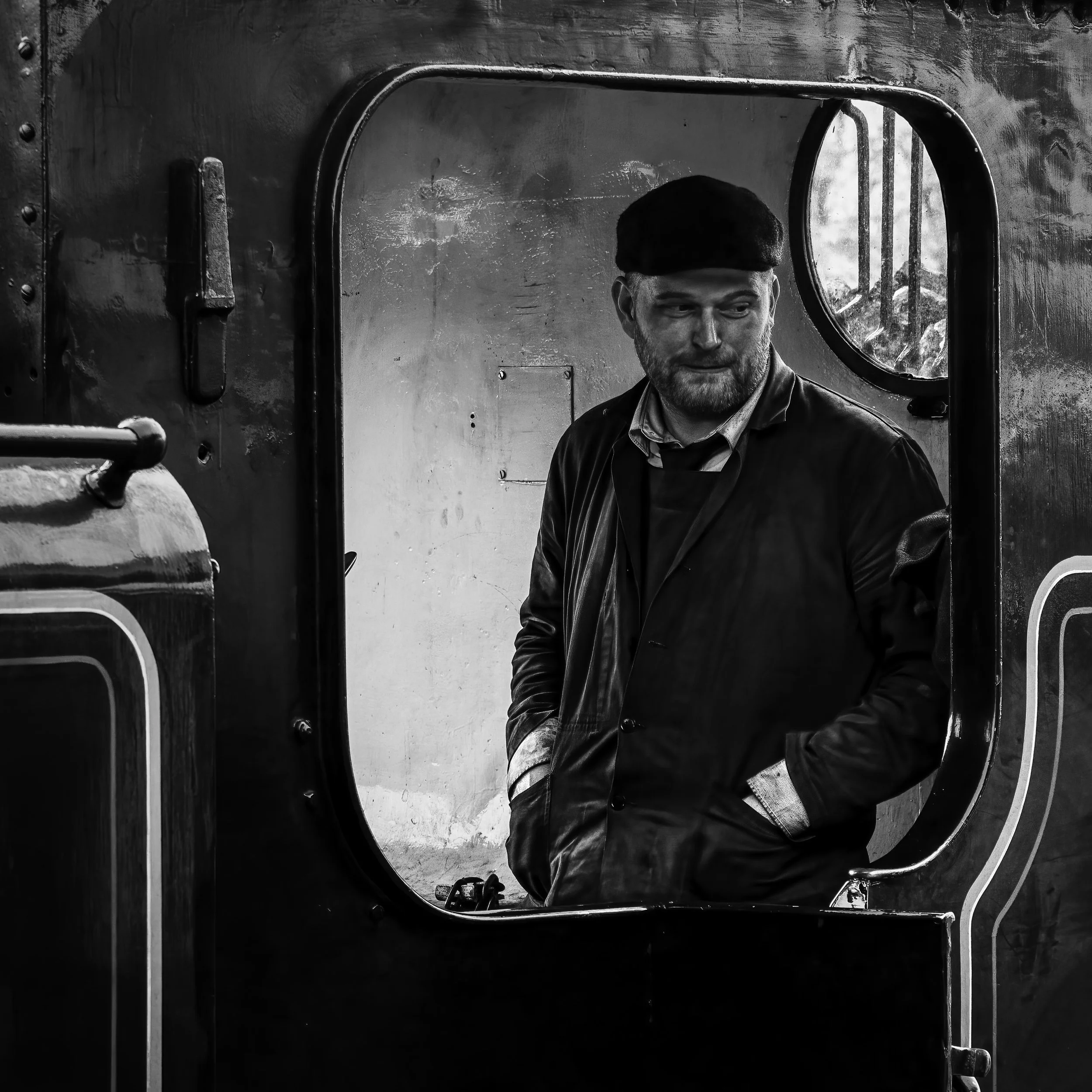 Flat capped steam railwayman