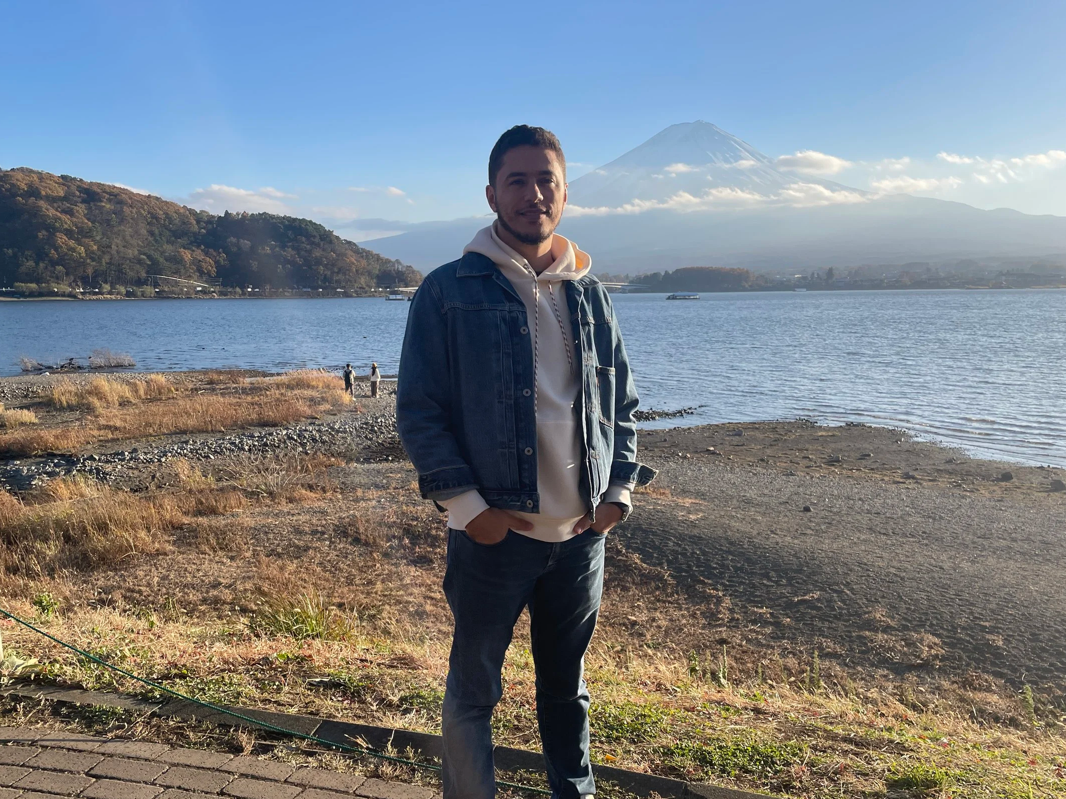 Mount Fuji in the background, with a lake across.