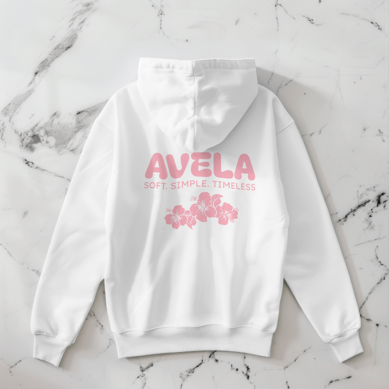 White hoodie with pink text and floral design, laid flat on a marble surface.