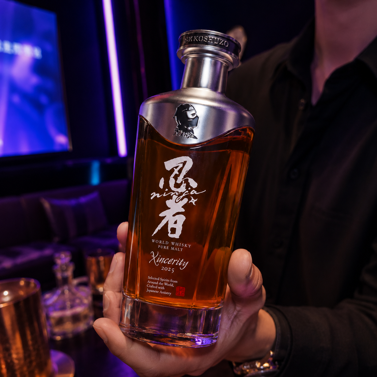 A person holding a bottle of Ninja World Whisky with a dark background and purple lighting.