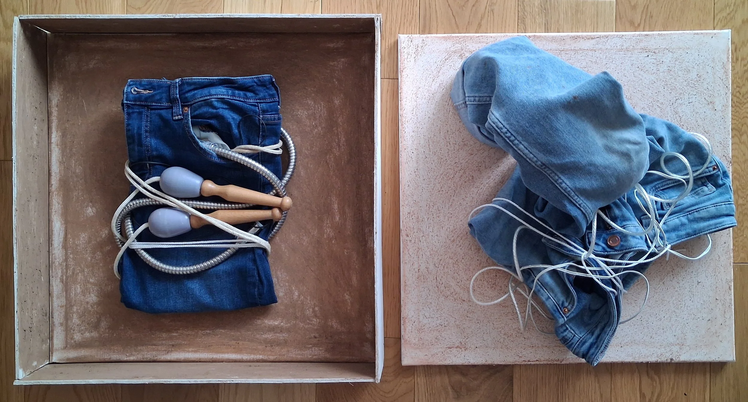 Constrained/Unconstrained, 2026, jeans, soil, sand, rope, washing line, phone cable, washing machine pipe on canvas and wood 