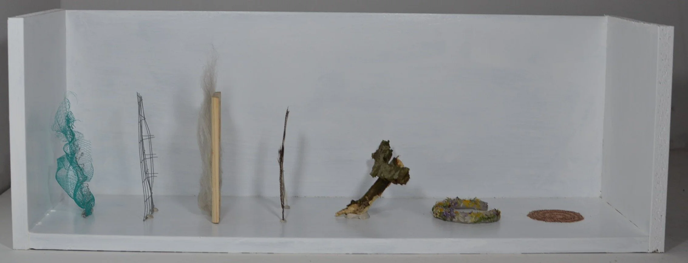 Journey back to nature, 2026, plastic netting, aluminium wire, wood, raw wool, feathers, bark, clay, wild flowers and sand