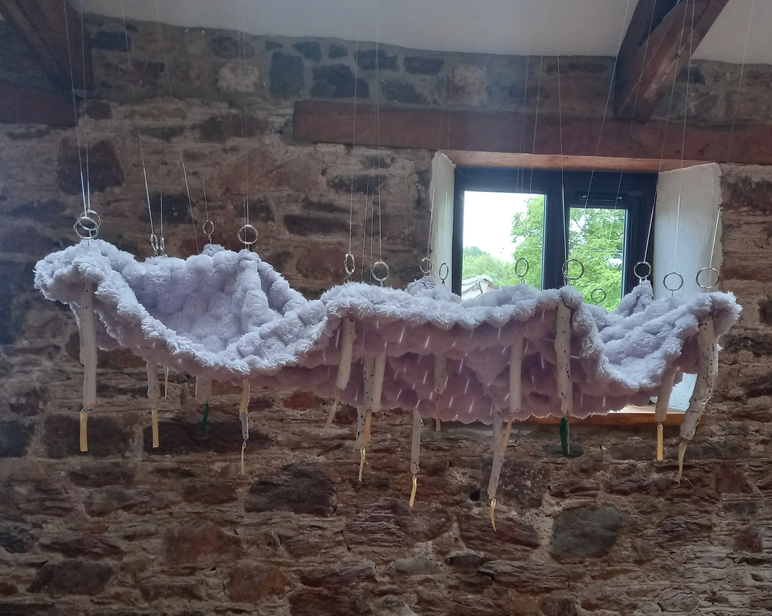 What it looks like to feel supported, 2025, blanket, sticks, acrylic, ribbon, ink, wire, hooks