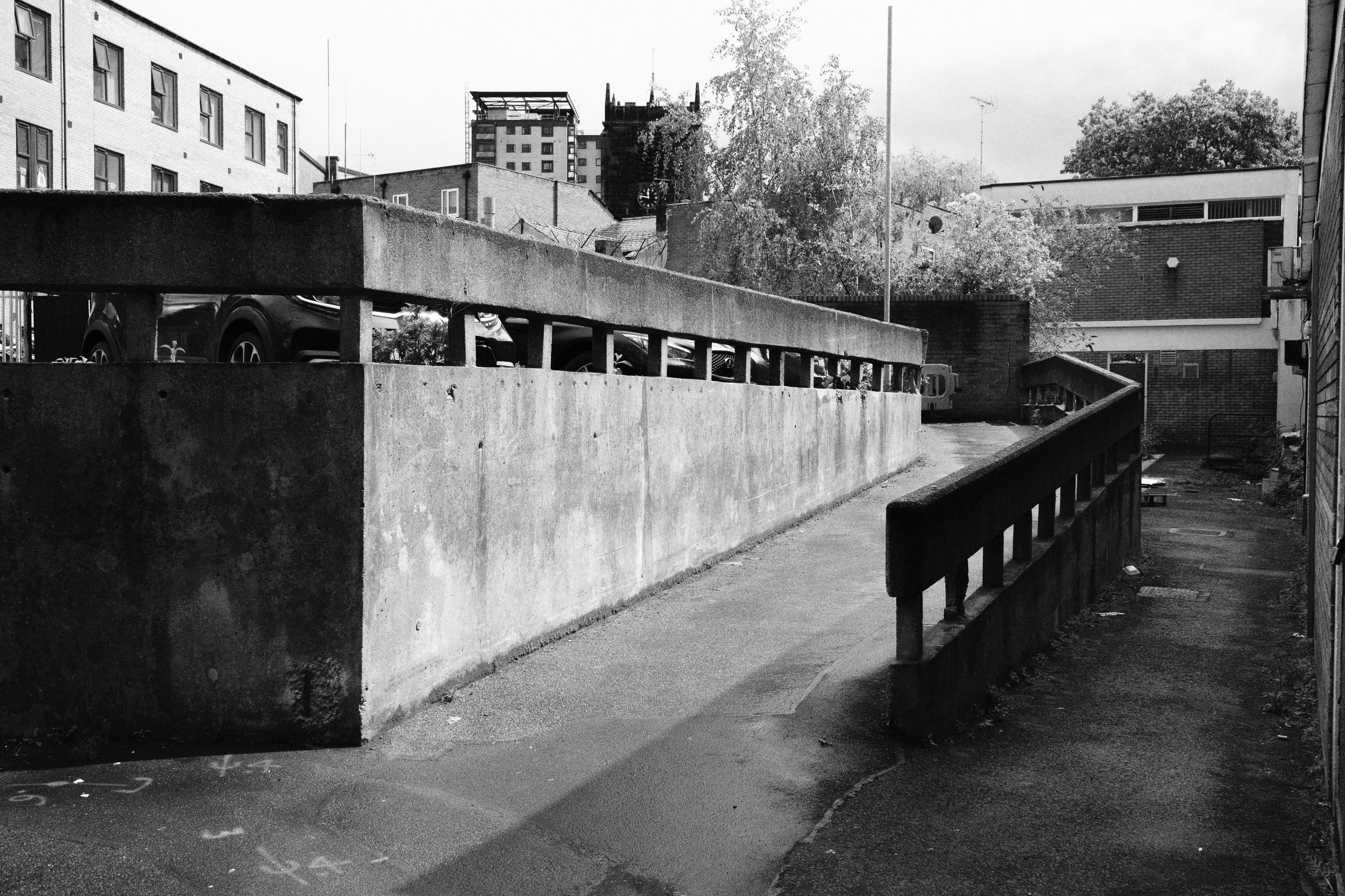 Black and white image of a footpath leading up to an Eccles car park