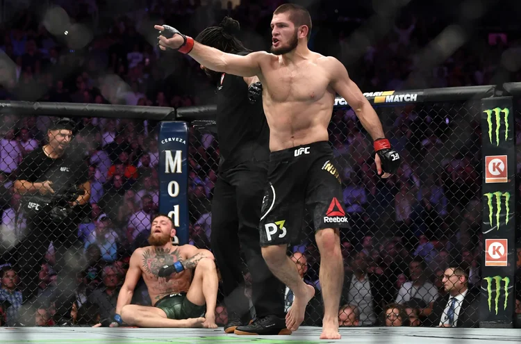 Khabib Nurmagomedov inside the octagon surrounded by branded partner signage on fight night