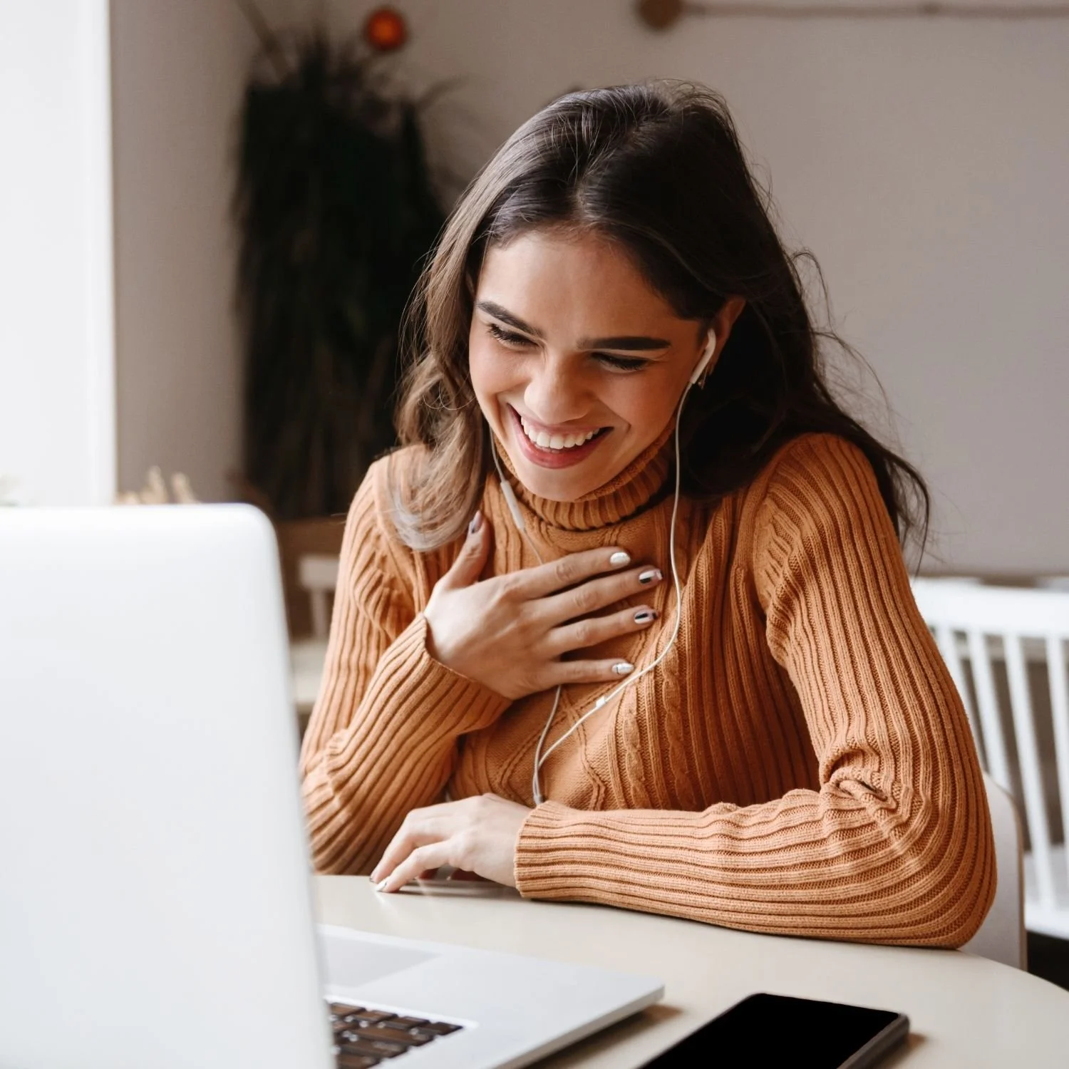 Smiling woman participating in an online wellness consultation, illustrating personalized support from a registered dietitian NYC focused on integrative body health and mind body health.