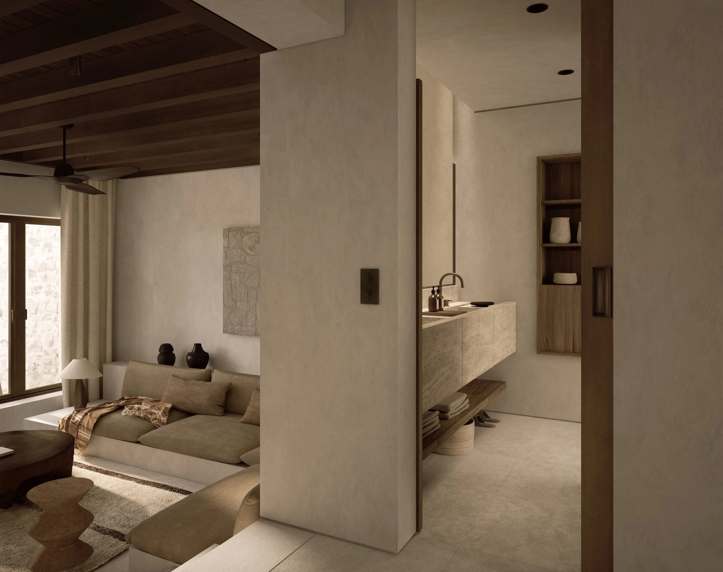 Interior view of a modern living space with a sofa, lamp, and window, separated by a wall with built-in shelves and decor items, in a neutral color palette.