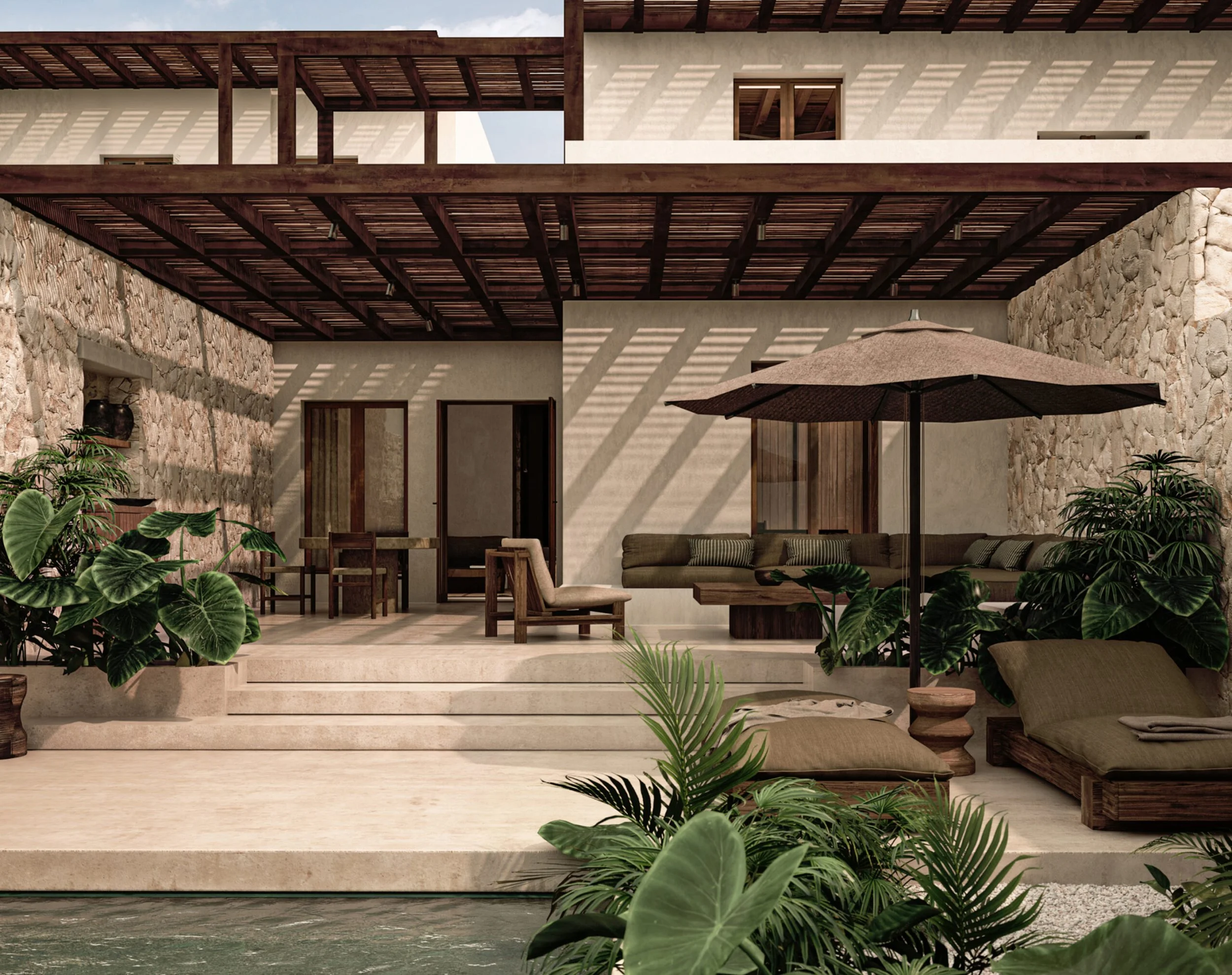 An outdoor patio area of a modern home with a stone wall, wooden furniture including chairs and a sofa, a large umbrella, and lush green plants. The area features steps leading to a balcony with wooden beams casting shadows on the wall.