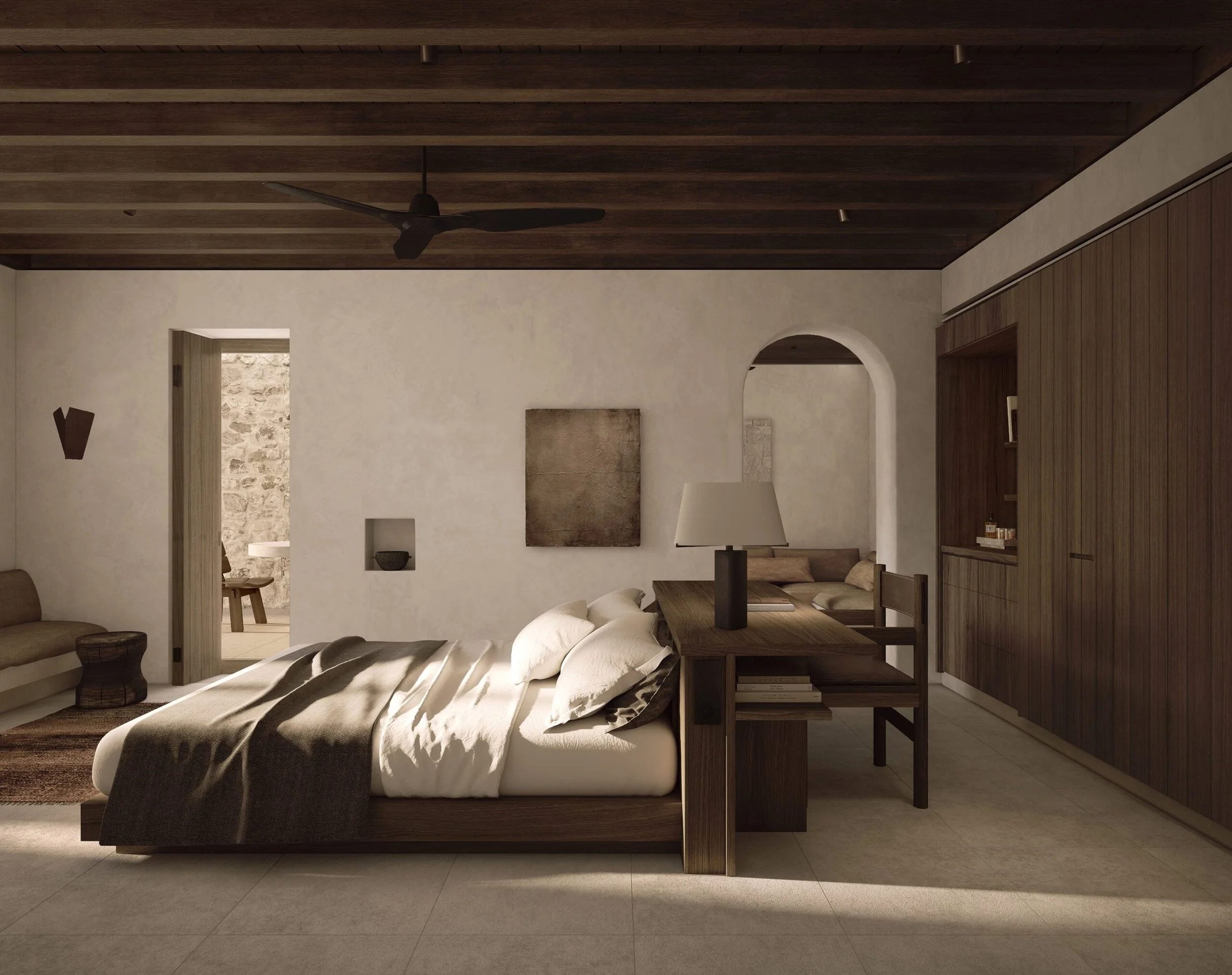 A modern bedroom with a low bed, white bedding, a bedside table with a lamp, a dark rug, wooden cabinetry, and a ceiling fan, with natural light coming through a window.
