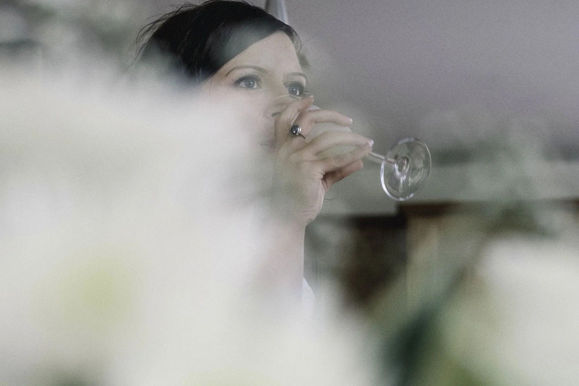 Bride having a drink of Champagne