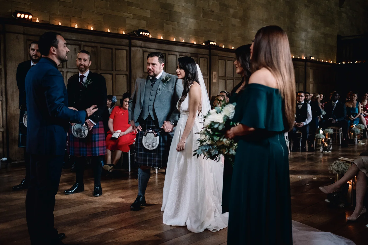  Bride and groom stand together at the top of the aisle in the Achnagairn Estate ballroom. 