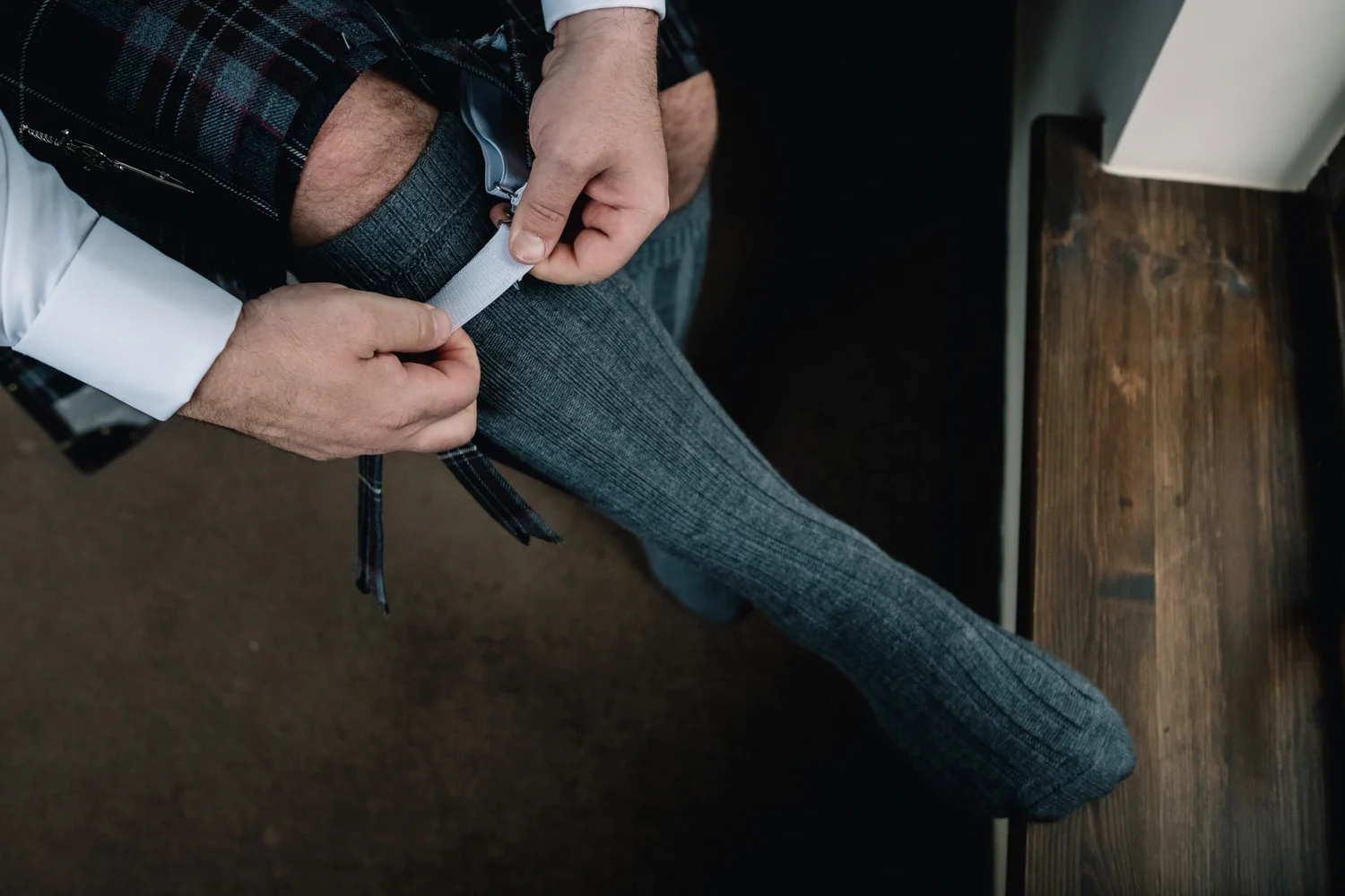  Groom fixing his socks. 