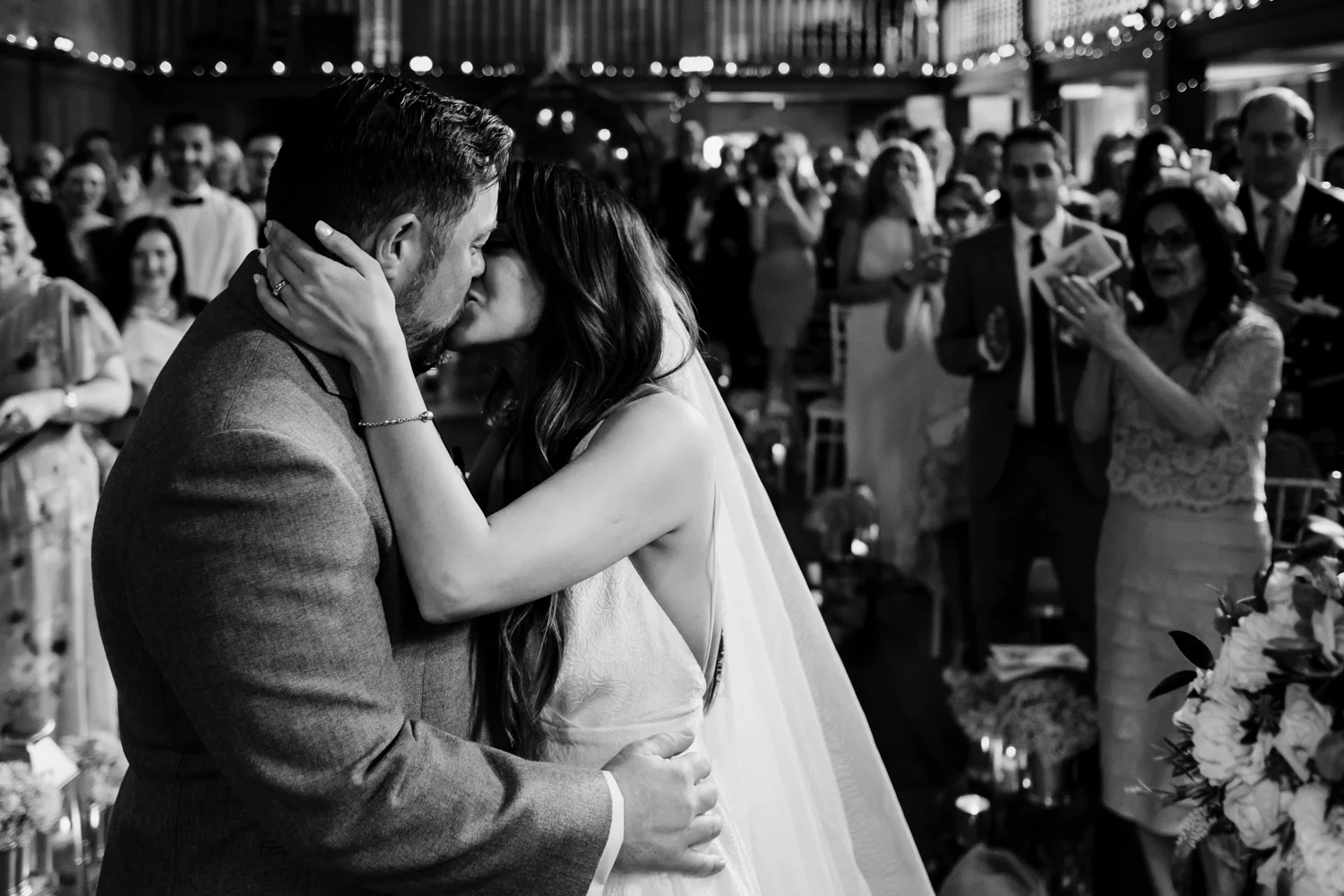 Bride + groom embrace as they exchange their first kiss. 