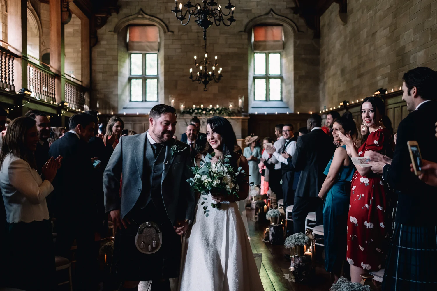  Bride looks at groom as they leave their wedding ceremony. 
