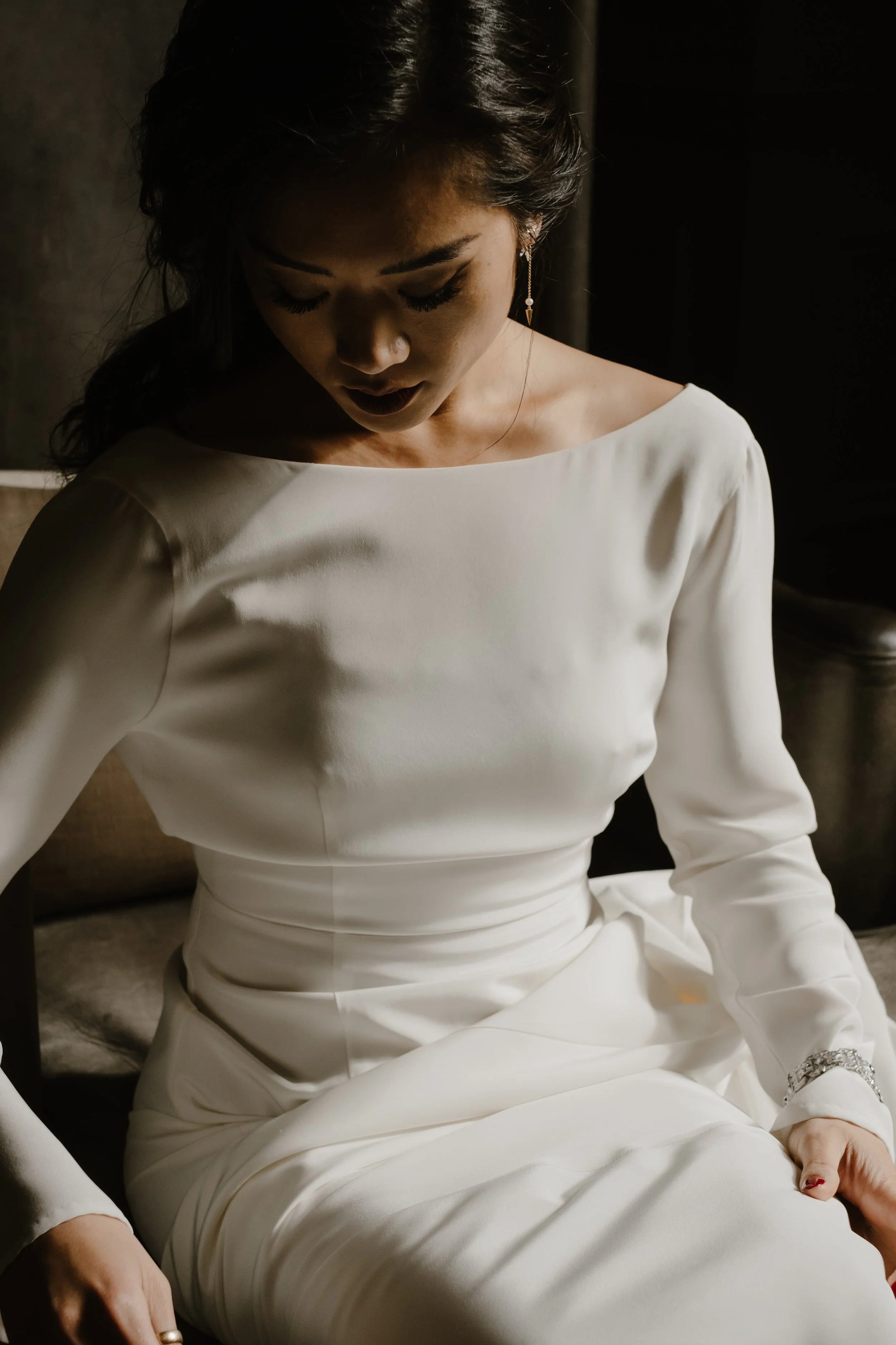 bride sitting looking down in beautiful light