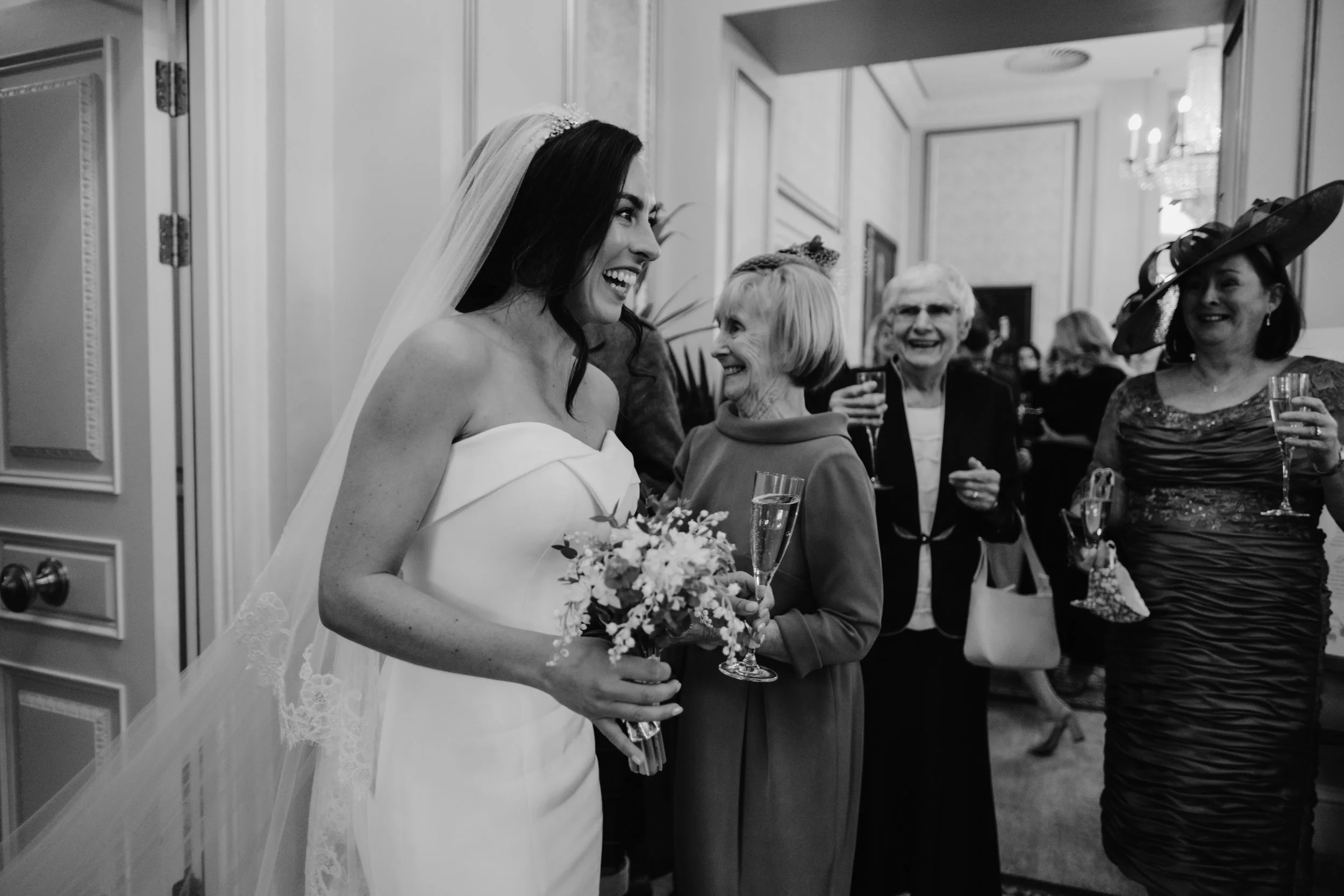 smiling bride walking into drinks reception
