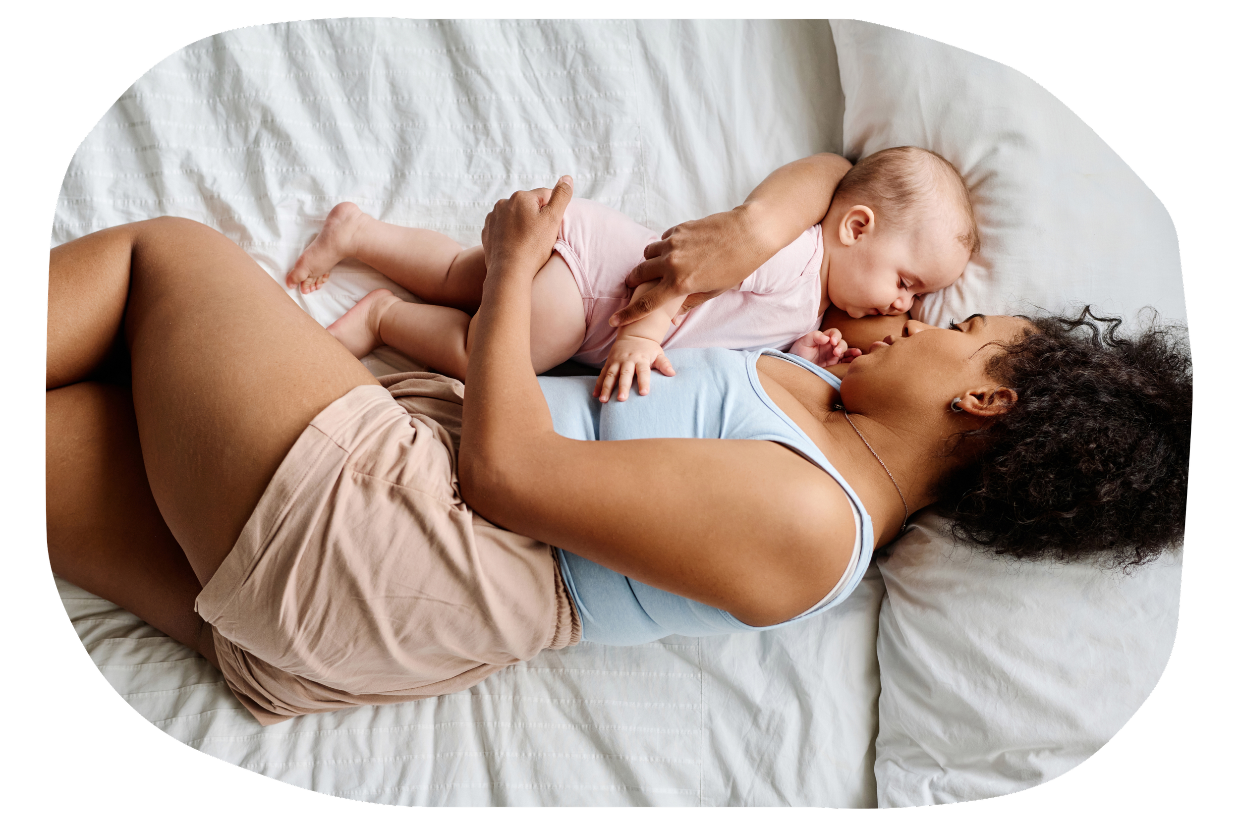 A woman lying on a bed with a baby next to her touching her face and arm. At Strong Roots OT, we're happy to provide community resources for everyone's needs including chiropractic care, pelvic floor therapy, counseling, and more.