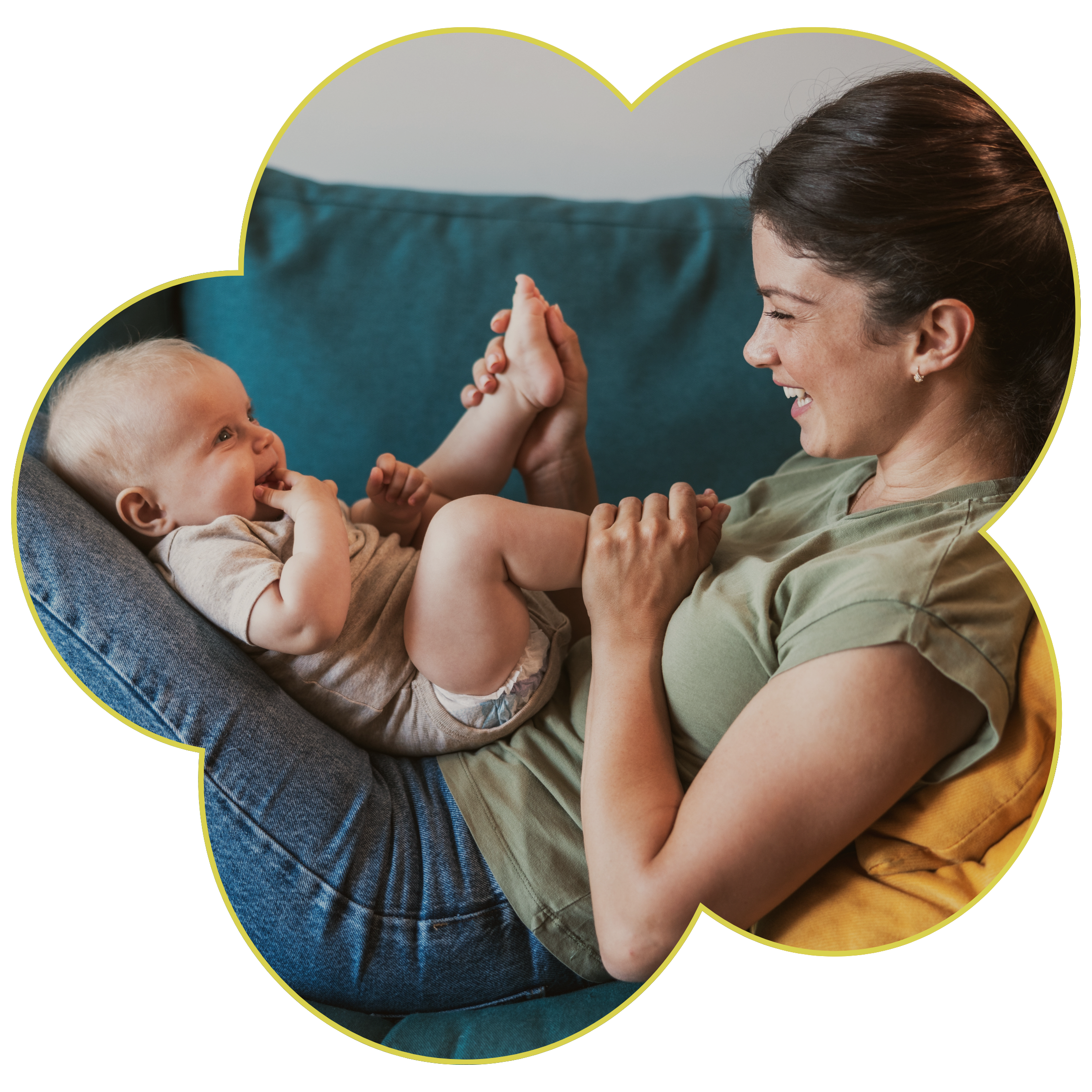 A woman and a young child playfully high-five each other indoors, sitting on a teal couch inside a flower frame to represent Strong Roots OT in south NJ and Philadelphia where we provide maternal health and pediatric occupational therapy services.