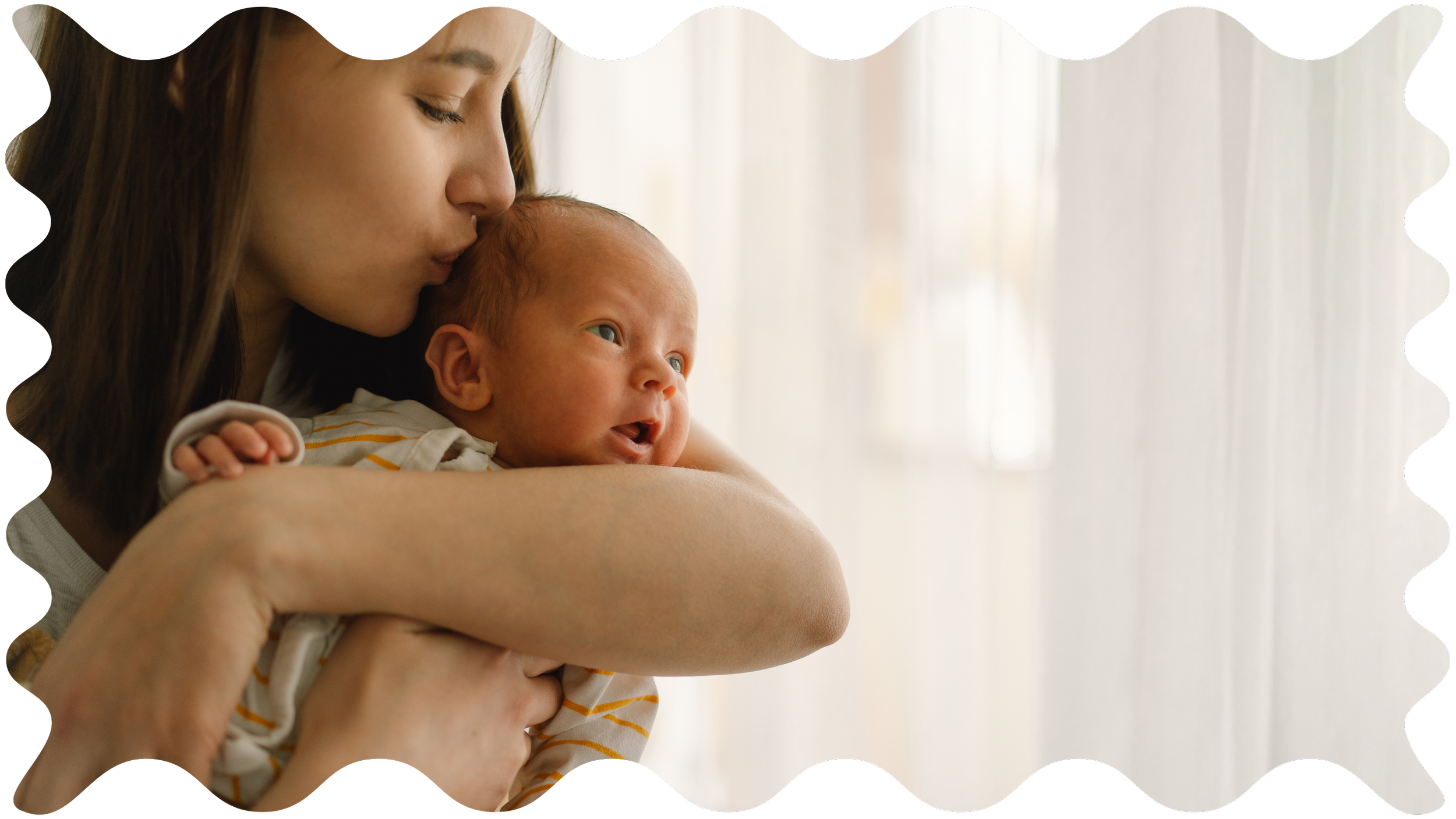 A woman with dark hair kissing her newborn baby, both looking out a window with soft lighting to represent Strong Roots OT and the occupational therapy they offer specializing in maternal health and pediatric occupational therapy.