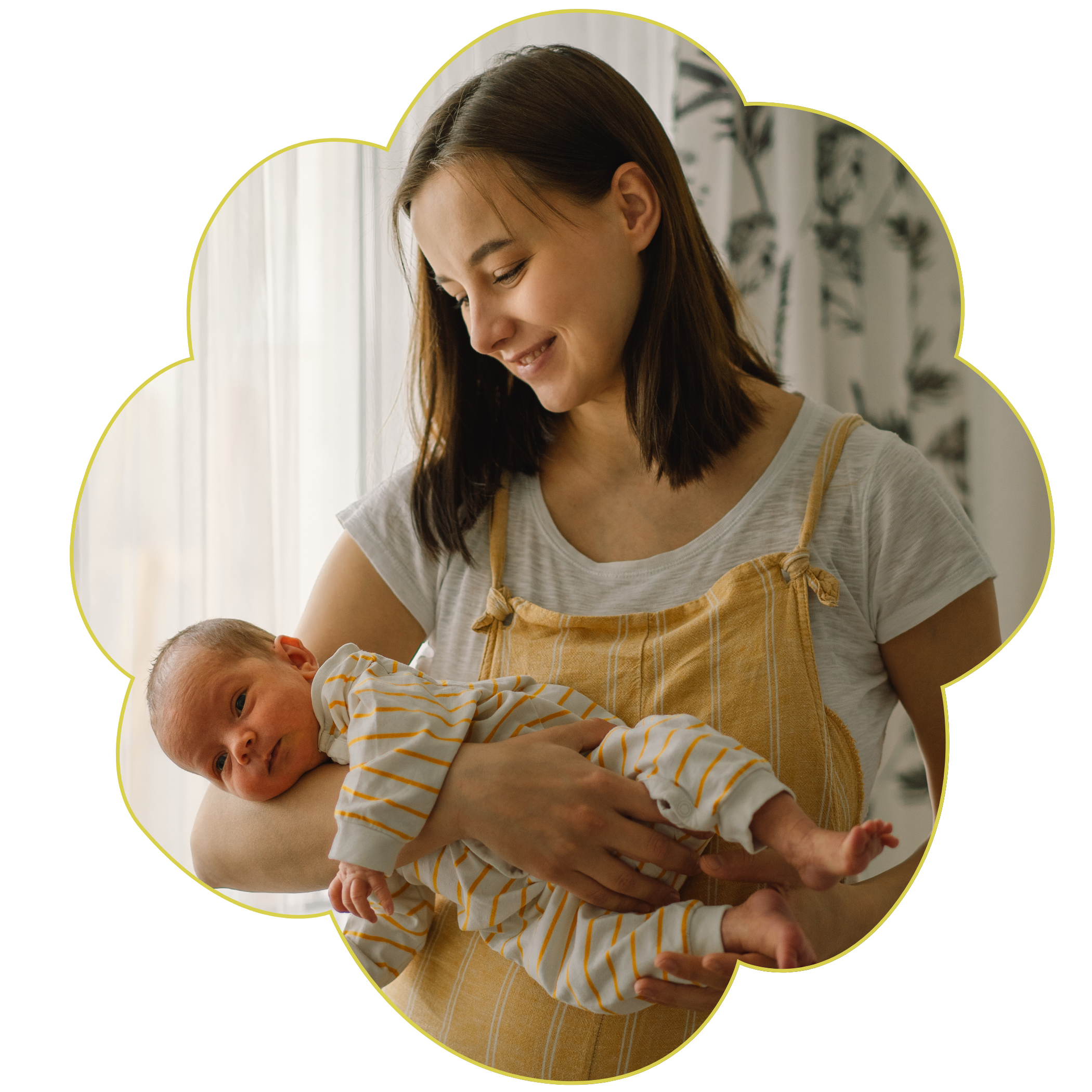 A woman with brown hair smiling while holding a baby, who is dressed in a yellow and white striped outfit, in a bright room with curtains and plants in the background with a flower frame for Strong Roots OT.