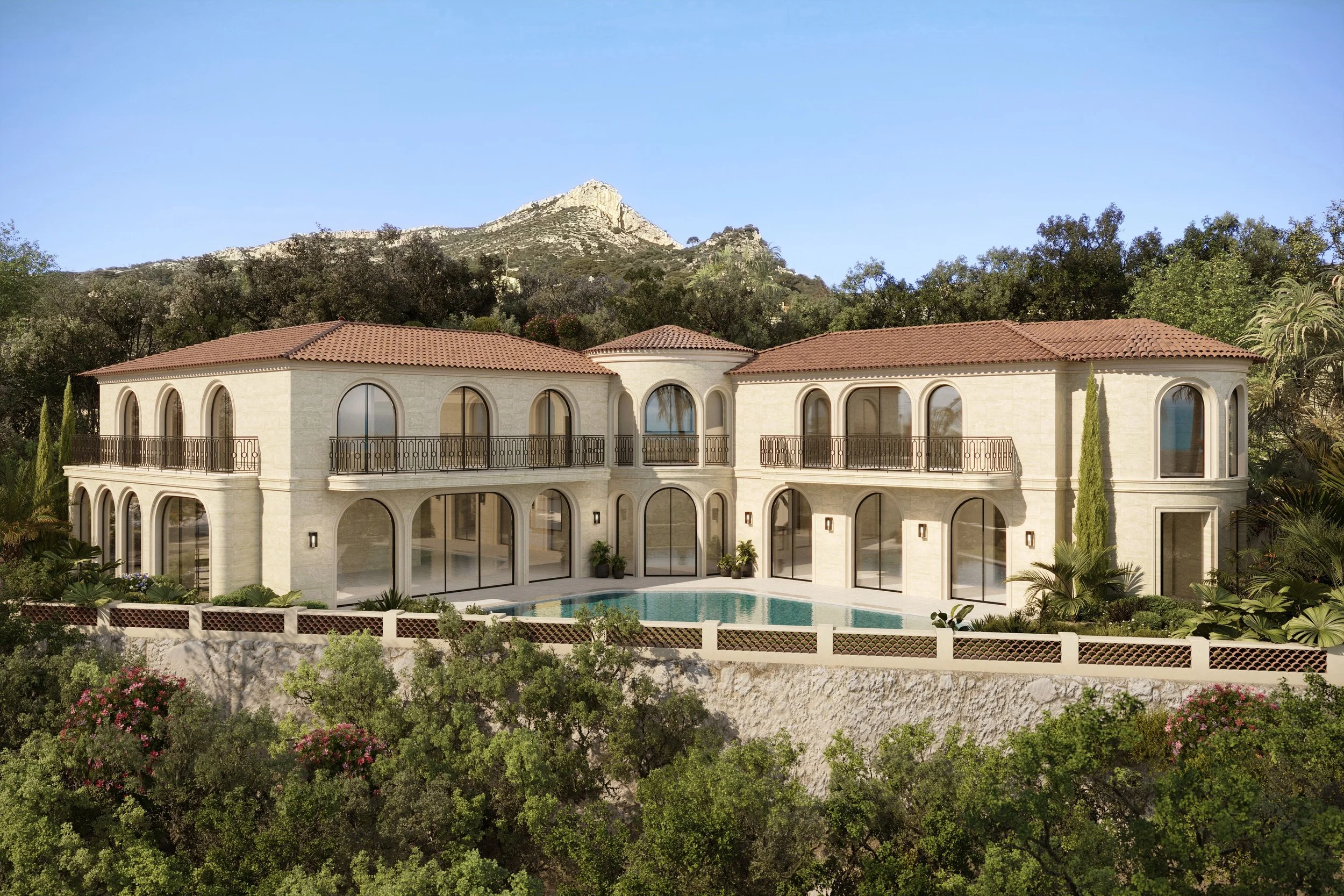 Maison élégante avec piscine, entourée de végétation, avec montagne en arrière-plan et ciel clair.