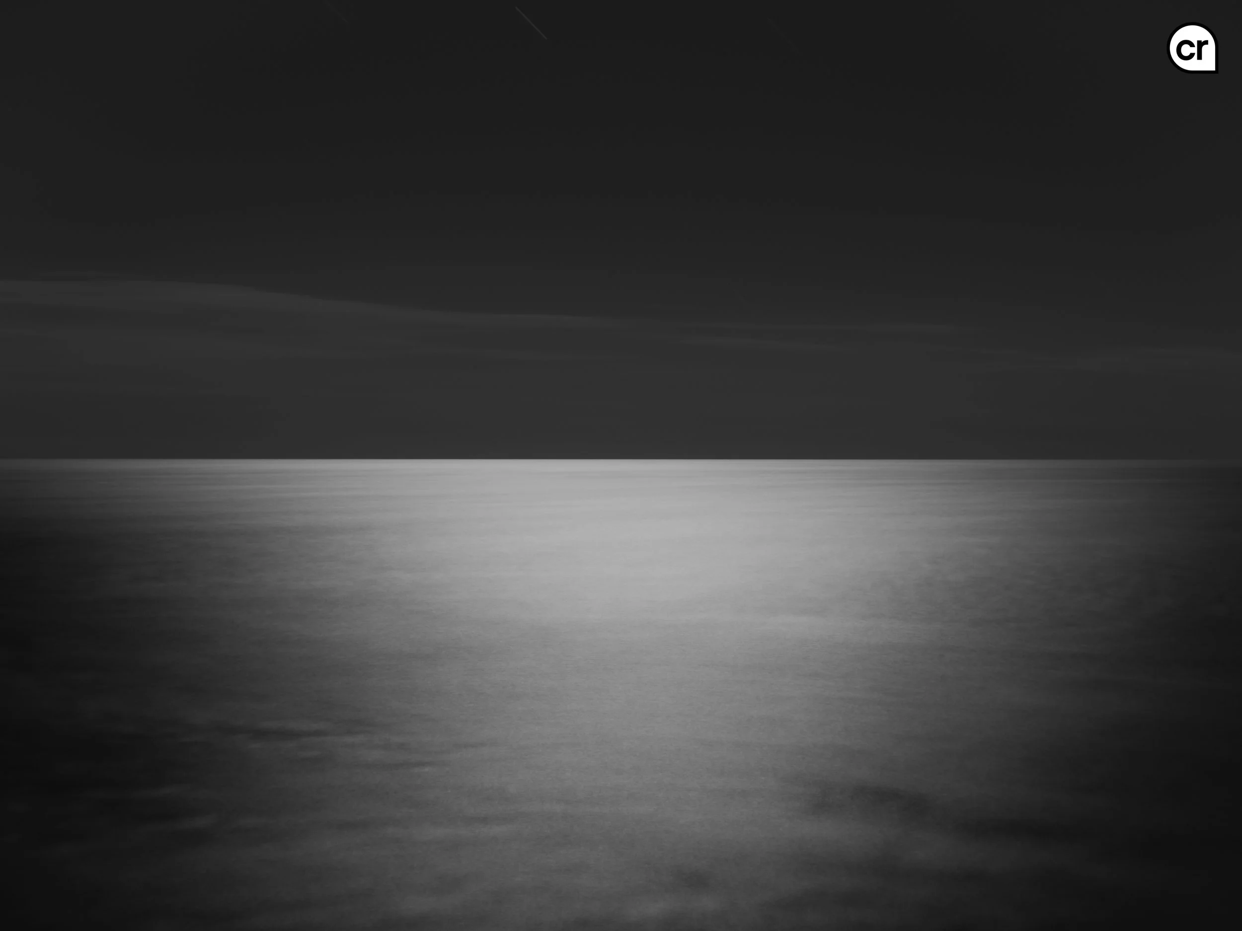 Black and white photograph of the moonlight on the Atlantic Ocean, Lisbon, Portugal. Made by Indigenous Design and Photography Ltd.