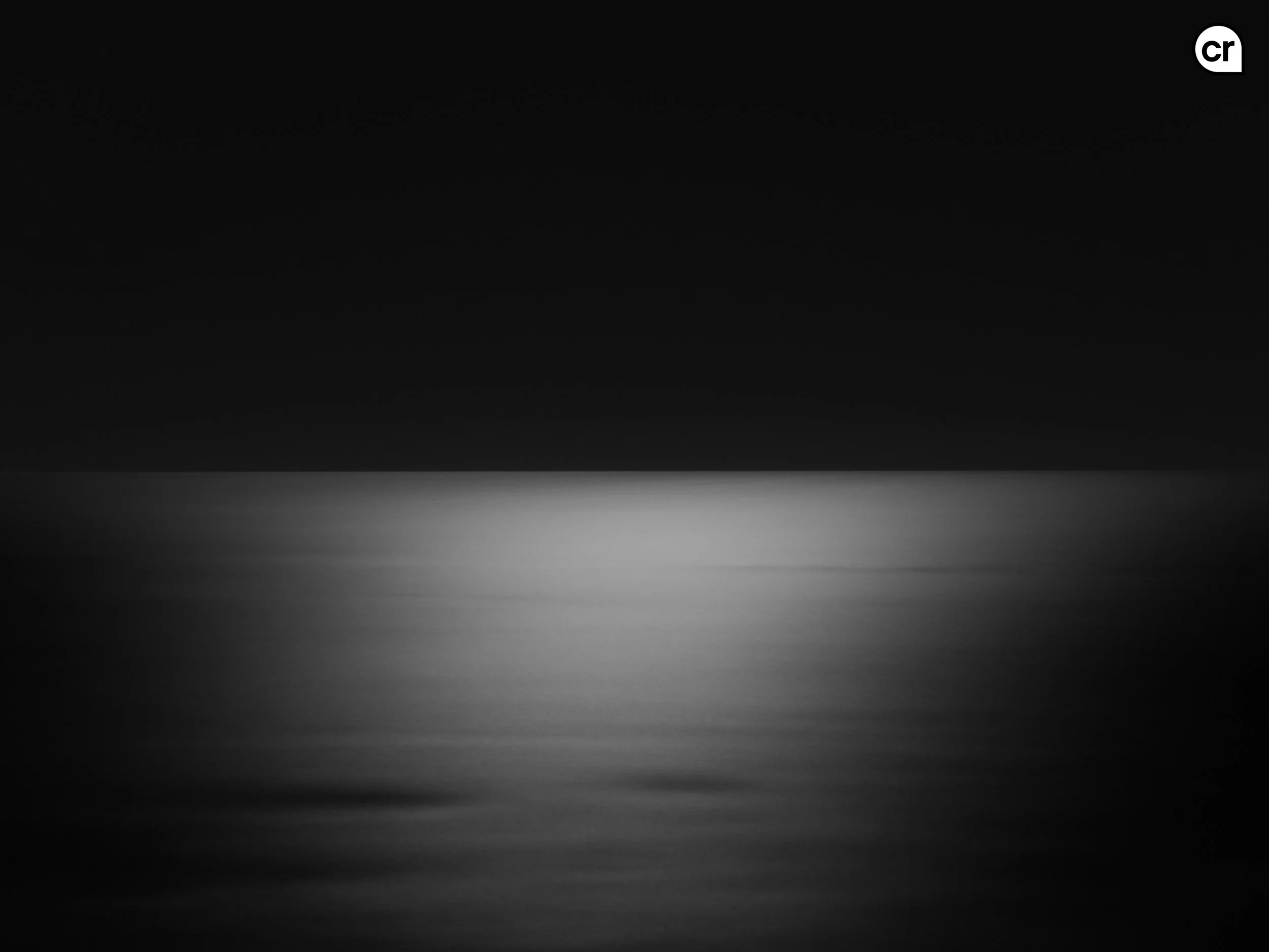 Black and white photograph of the moonlight on the Atlantic Ocean, Lisbon, Portugal. Made by Indigenous Design and Photography Ltd.