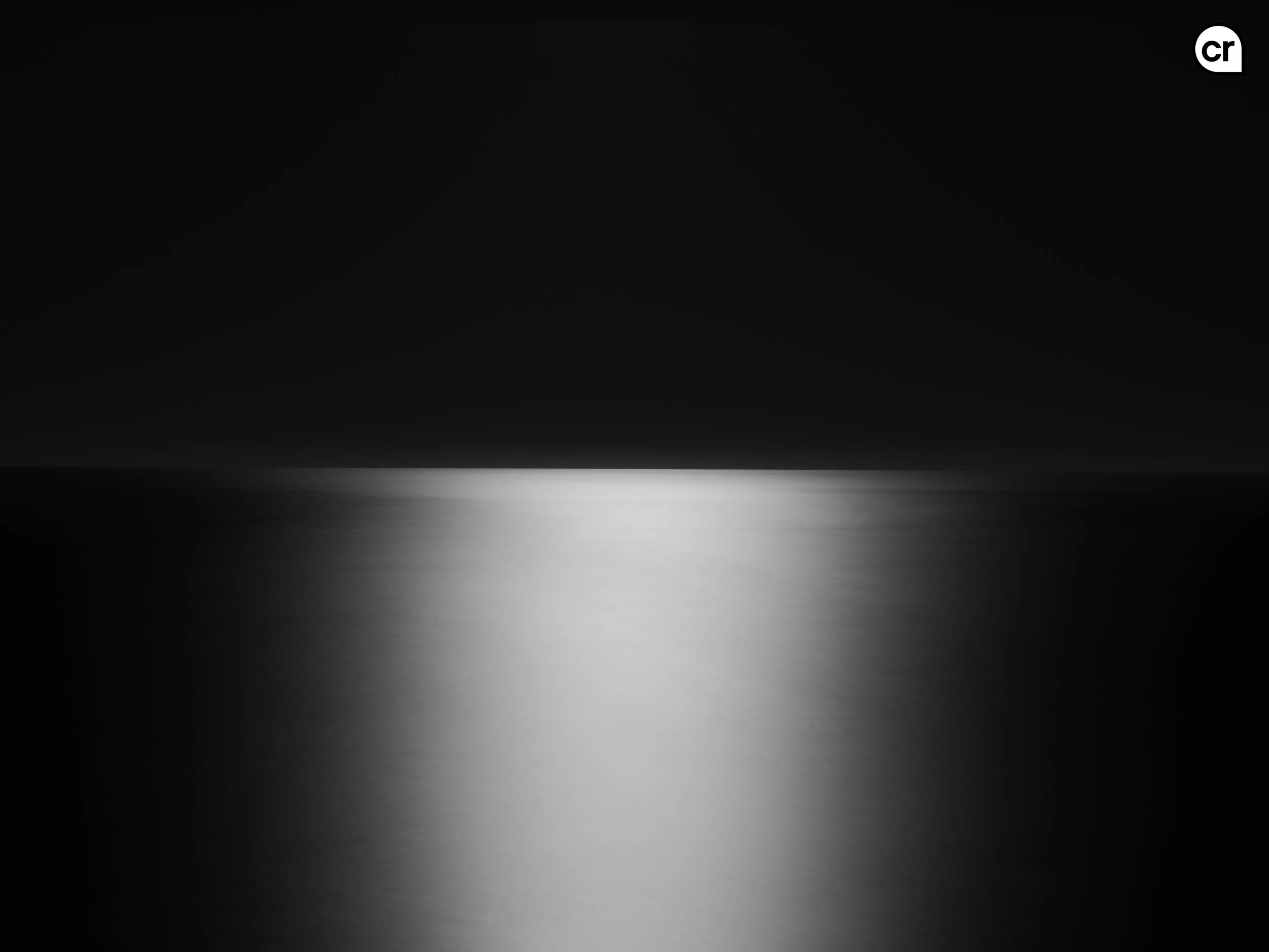 Black and white photograph of the moonlight on the Atlantic Ocean, Lisbon, Portugal. Made by Indigenous Design and Photography Ltd.