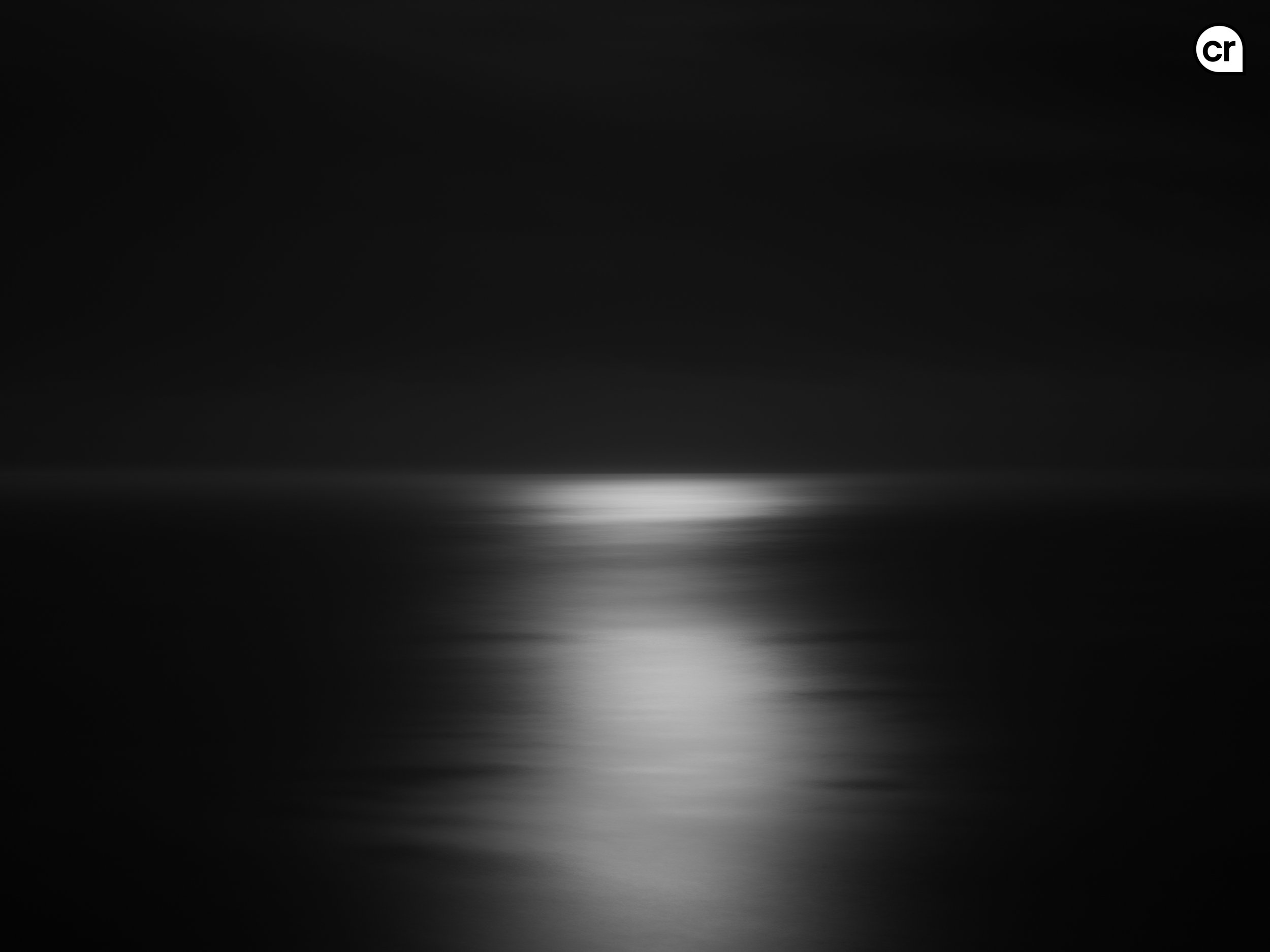 Black and white photograph of the moonlight on the Atlantic Ocean, Lisbon, Portugal. Made by Indigenous Design and Photography Ltd.