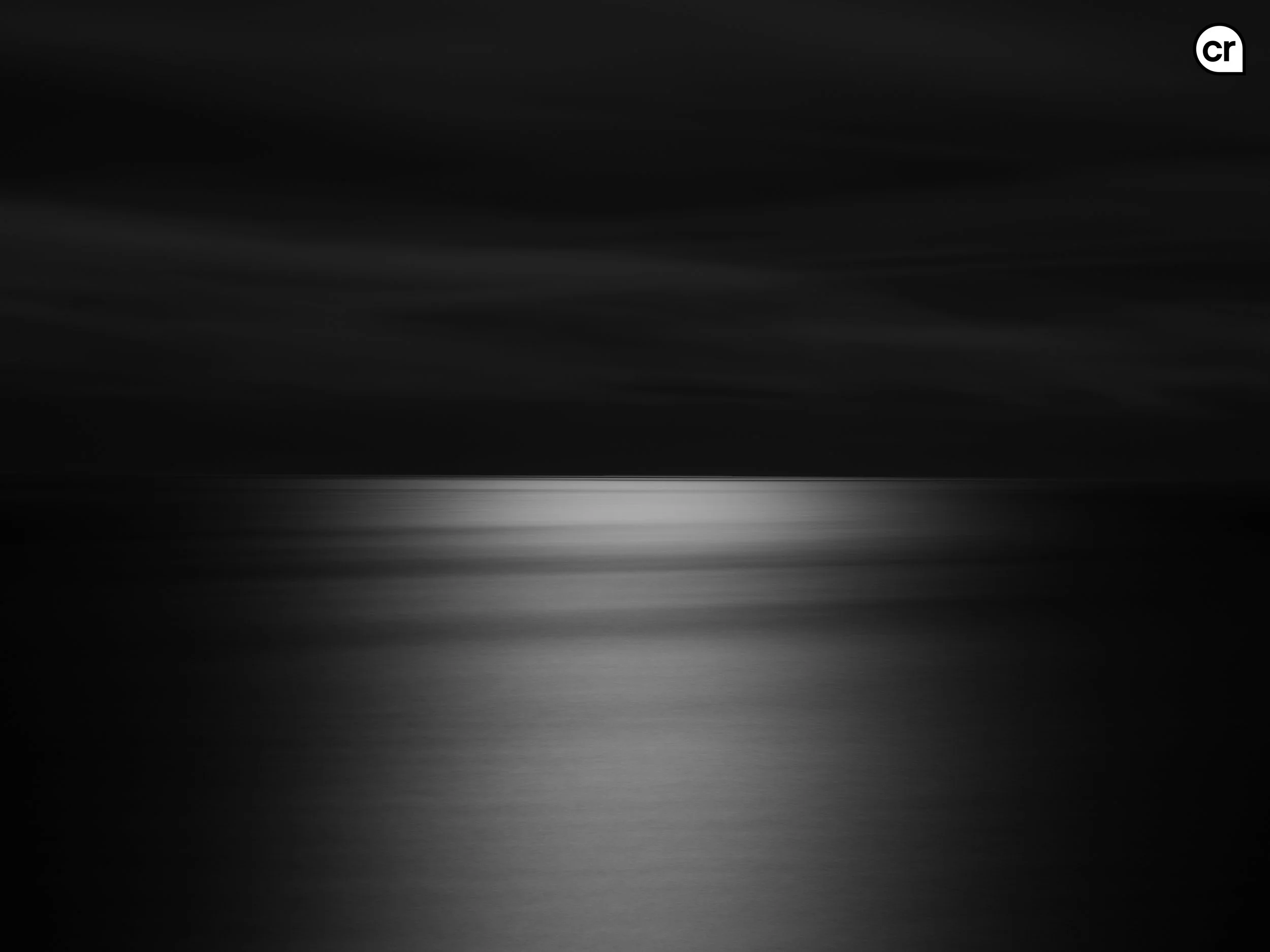 Black and white photograph of the moonlight on the Atlantic Ocean, Lisbon, Portugal. Made by Indigenous Design and Photography Ltd.