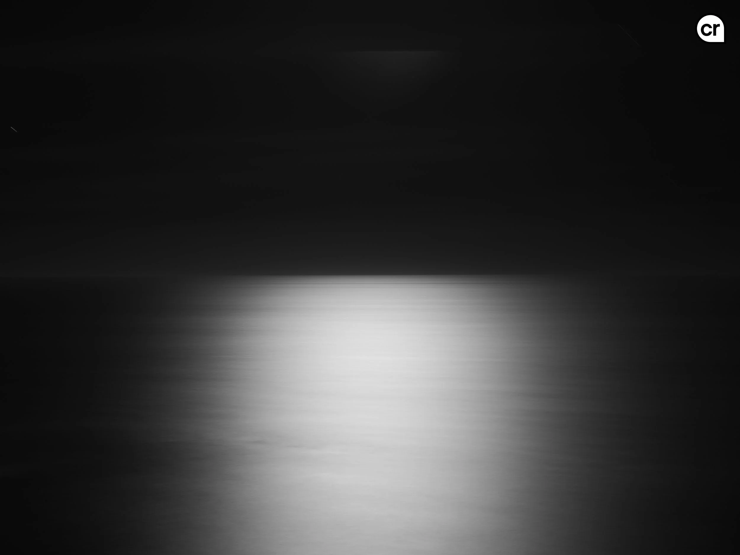 Black and white photograph of the moonlight on the Atlantic Ocean, Lisbon, Portugal. Made by Indigenous Design and Photography Ltd.