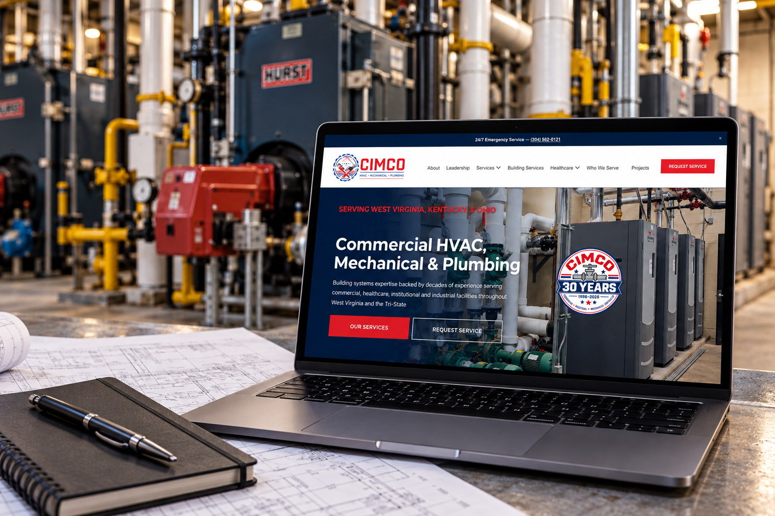 CIMCO website displayed on a laptop with blueprints in a commercial boiler and mechanical room.