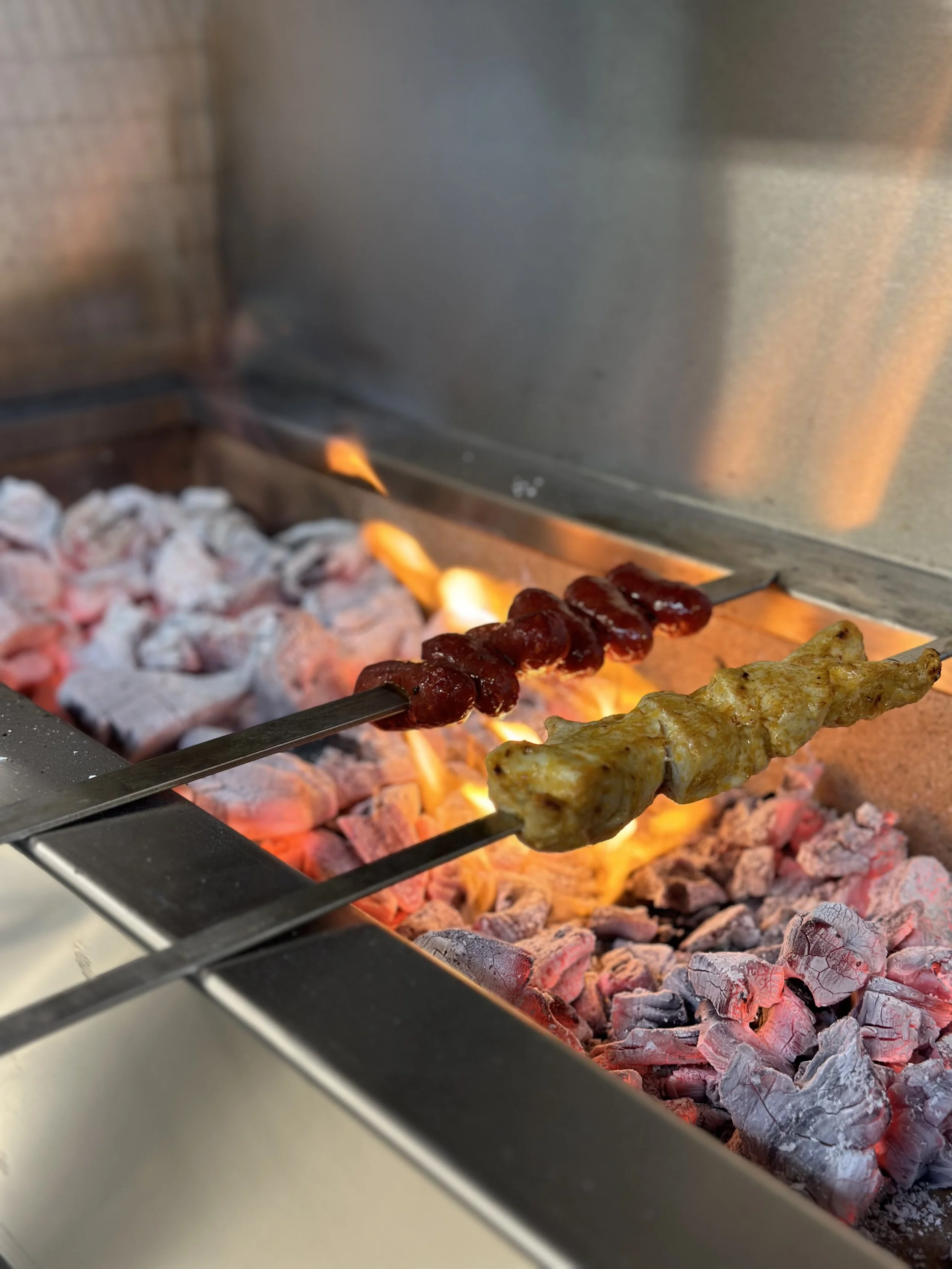 Shish taouk and Makanek sausages Skewers being barbecued in Noura Kingston
