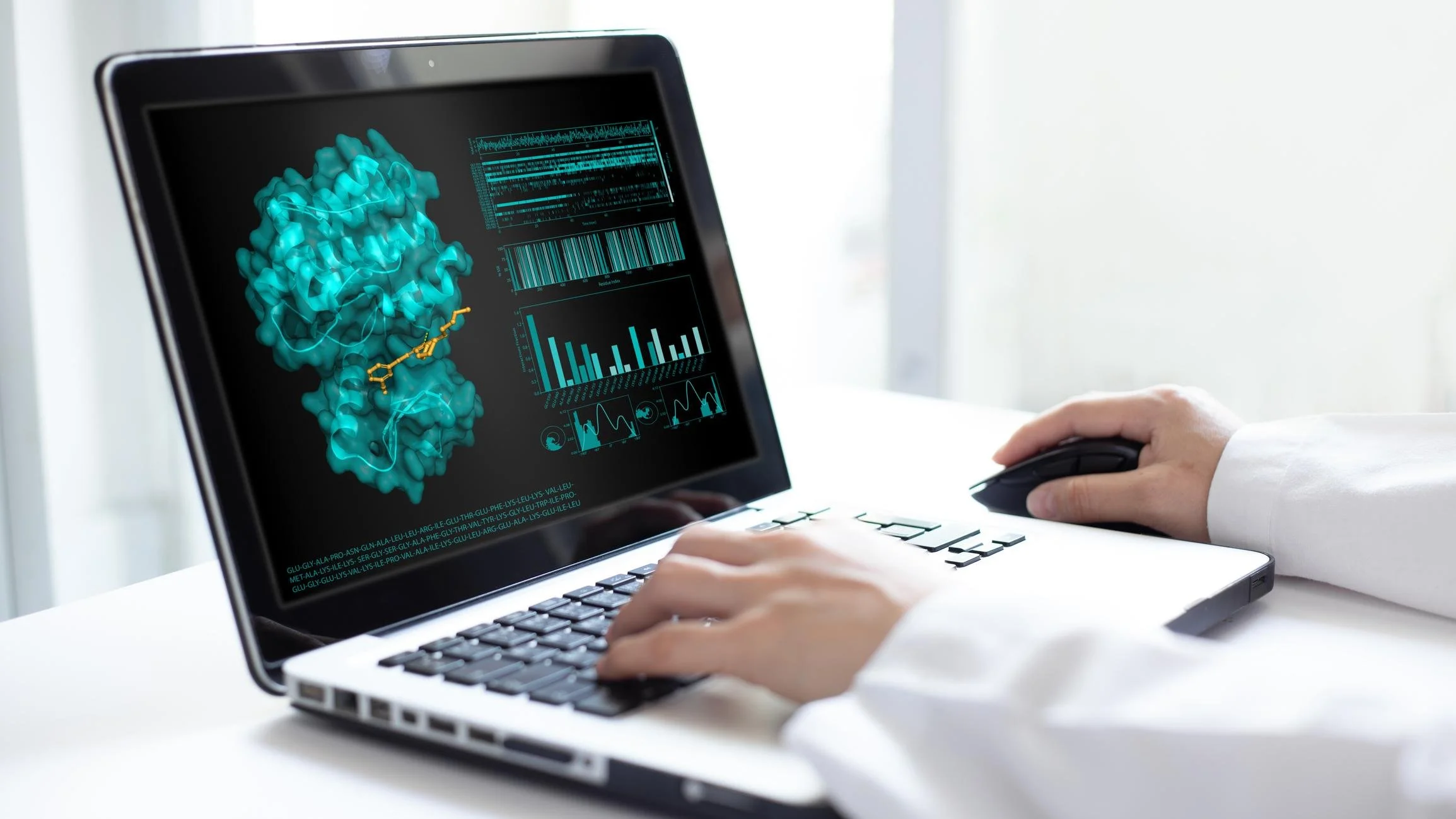Person using a laptop with a scientific visualization of a molecule, bar graphs, and data charts on the screen.