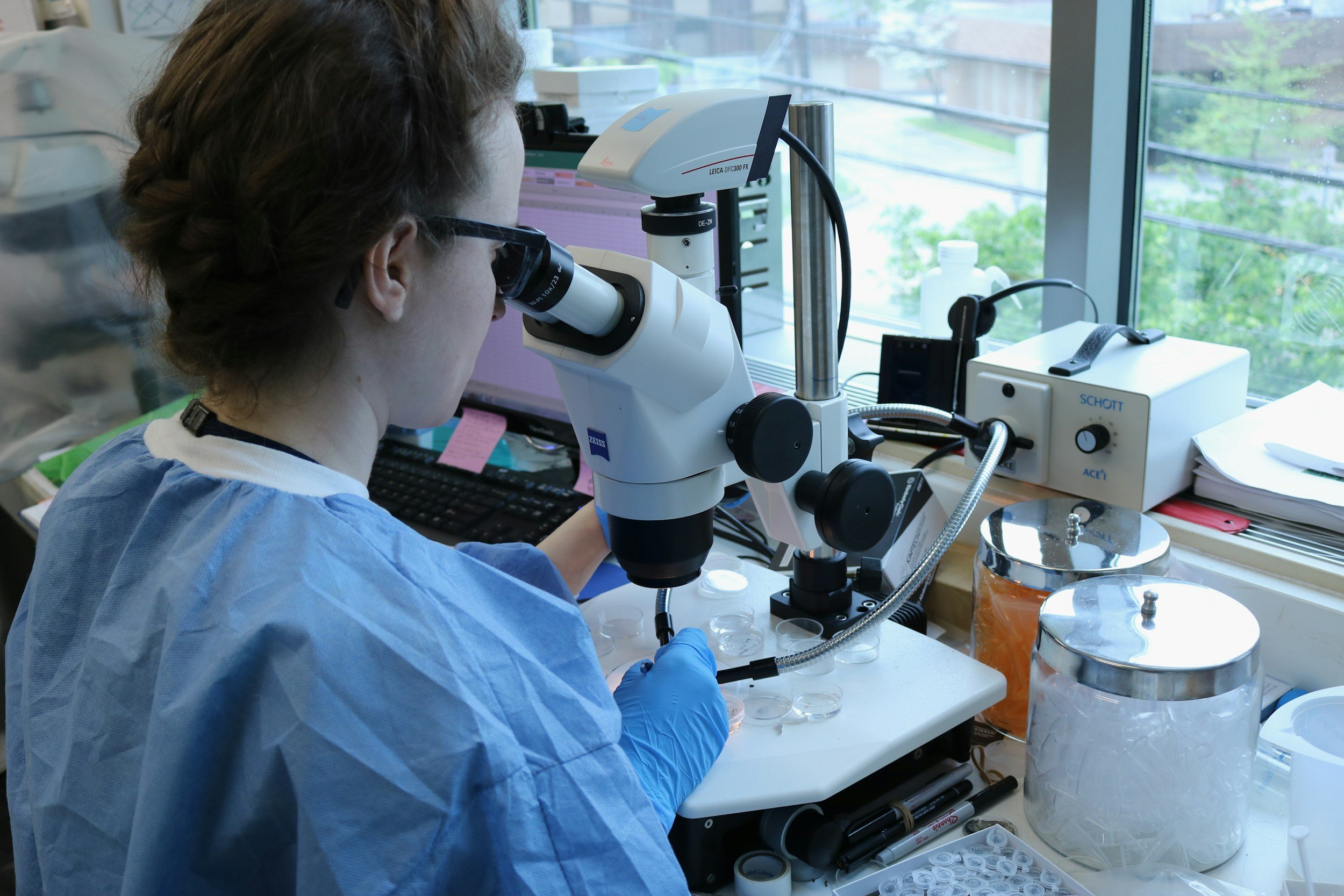 Biotech researcher at a microscope in a laboratory