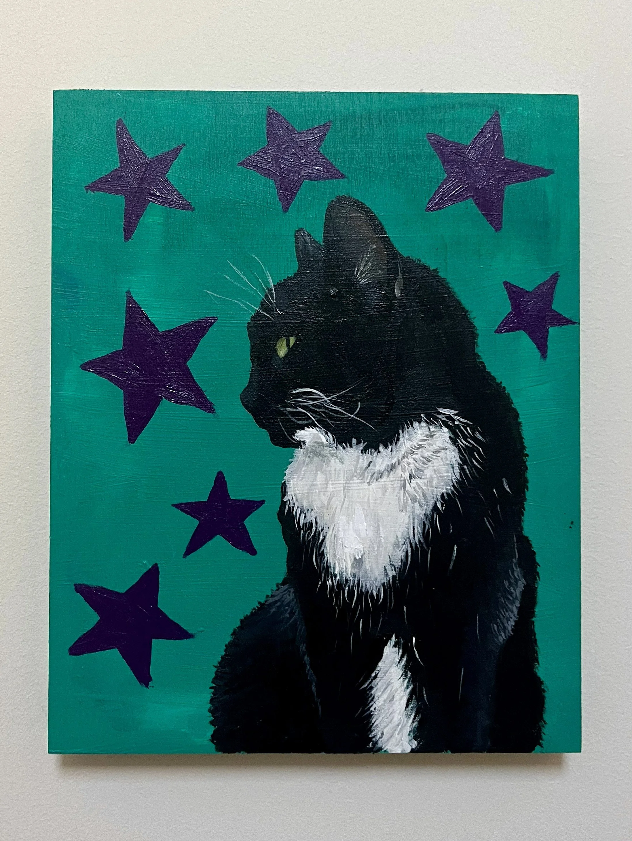 Painting of a black cat with white chest and green eyes, surrounded by purple stars, set against a teal background.