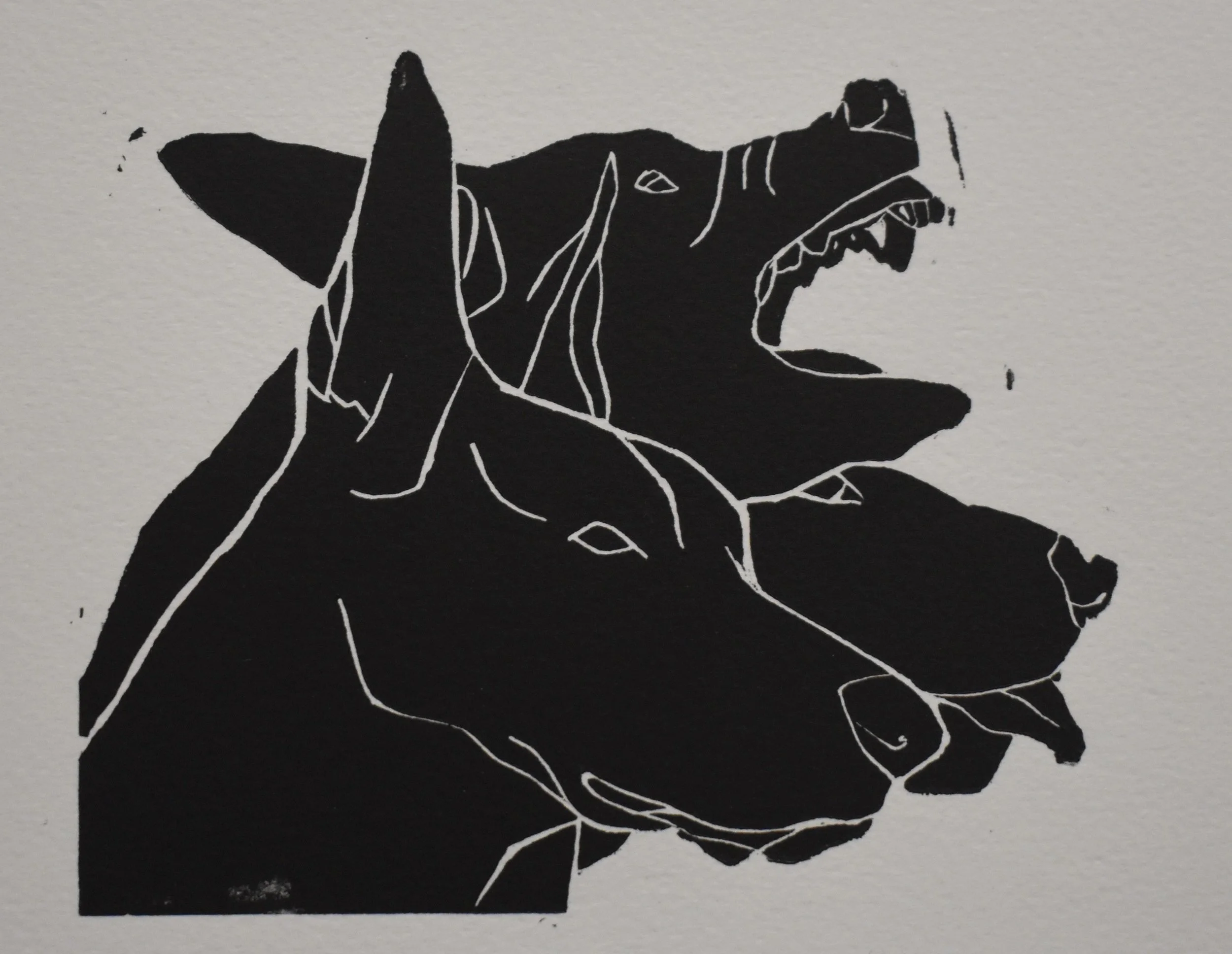 Black and white lino print of a three headed dog .