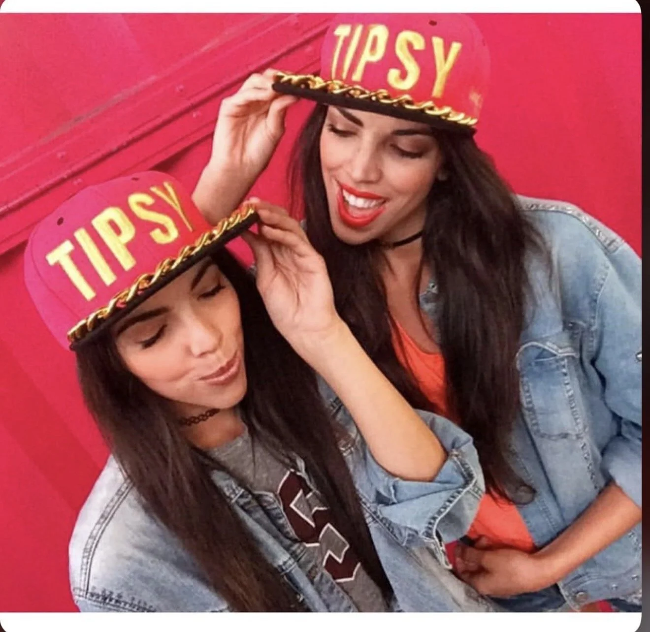 Two women wearing red 