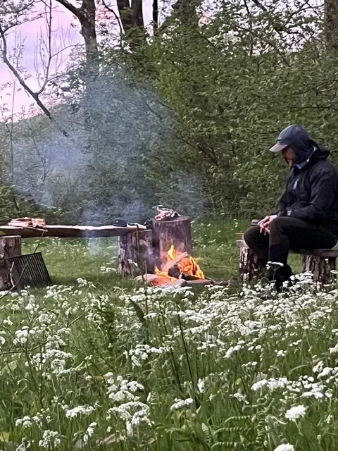 A man tending to a firepit