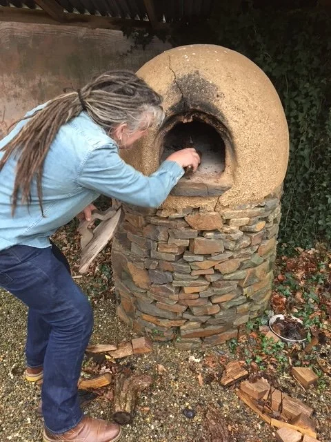 Gwilliam tending to the pizza oven
