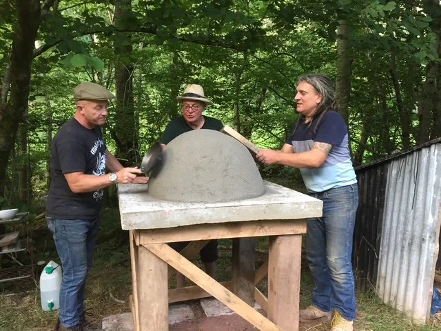 Gwilliam and volunteers making the pizza oven