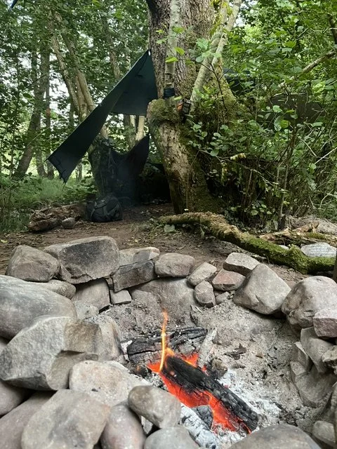 A hammock and bivvie close to the firepit