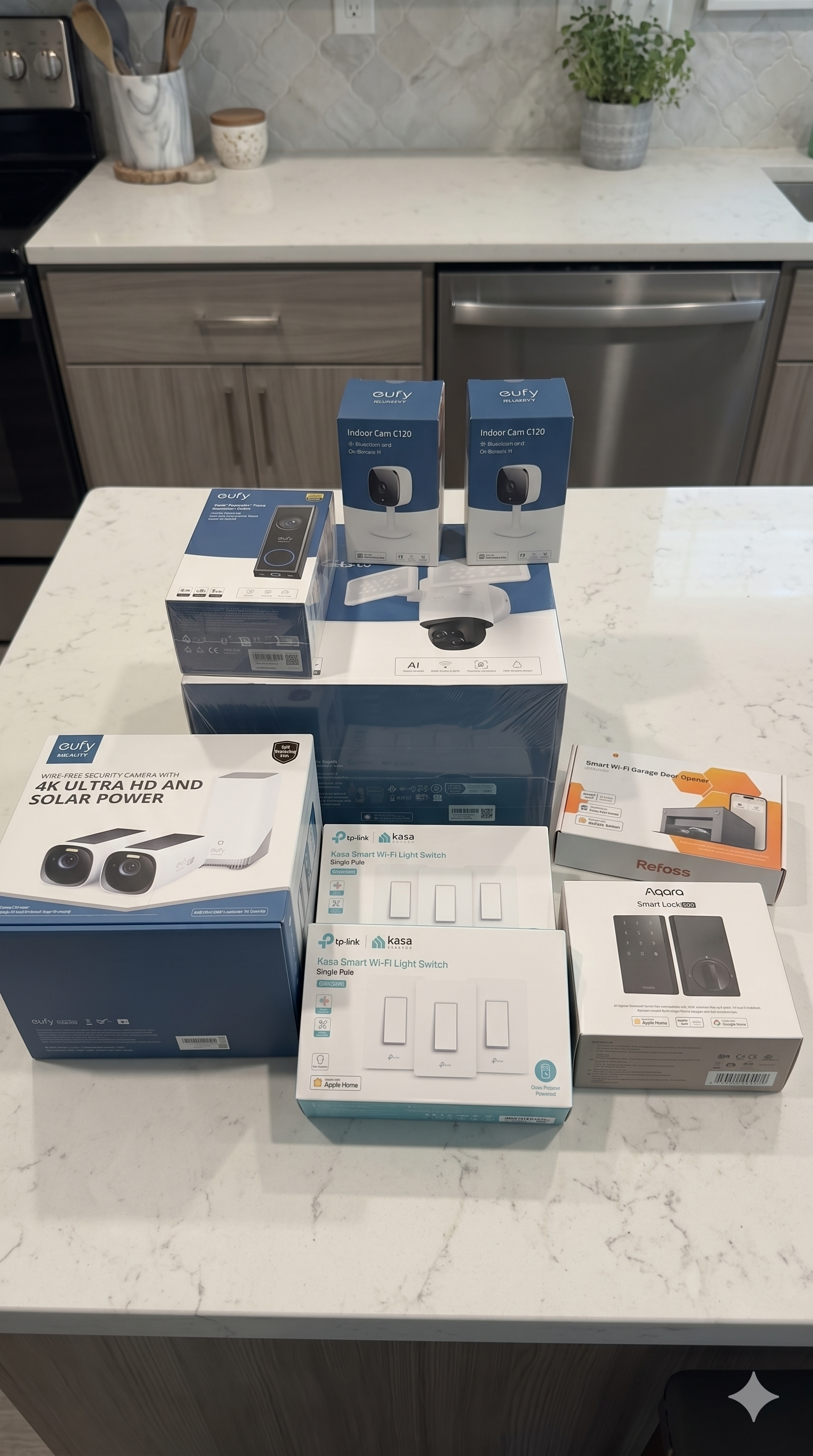 Various home security devices and smart light switches displayed on a kitchen island countertop, including security cameras, a Wi-Fi light switch, and a garage door opener.