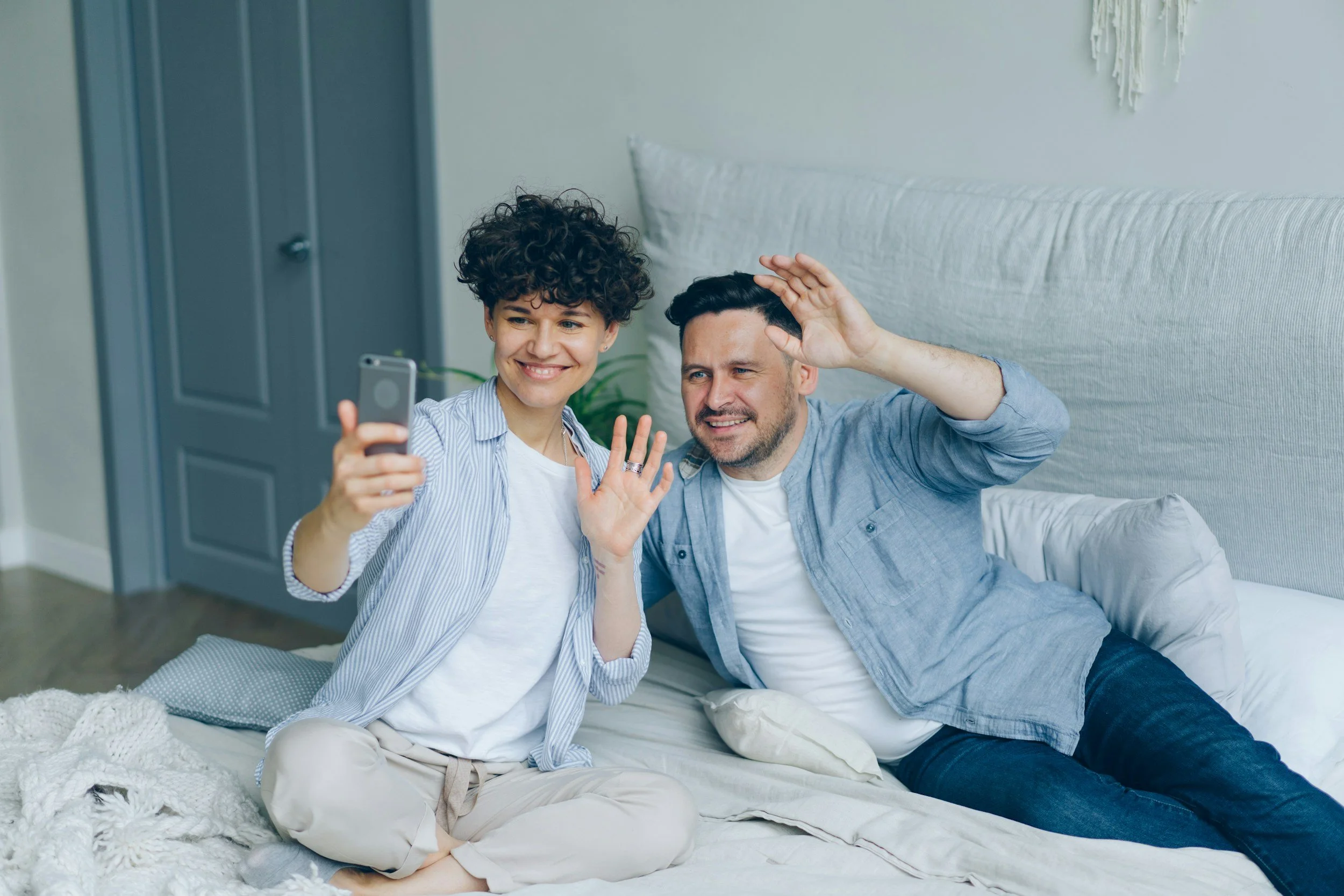 Deux personnes échangeant avec le sourire en visioconférence LSF sur smartphone pour un accompagnement à distance fluide et rapide.
